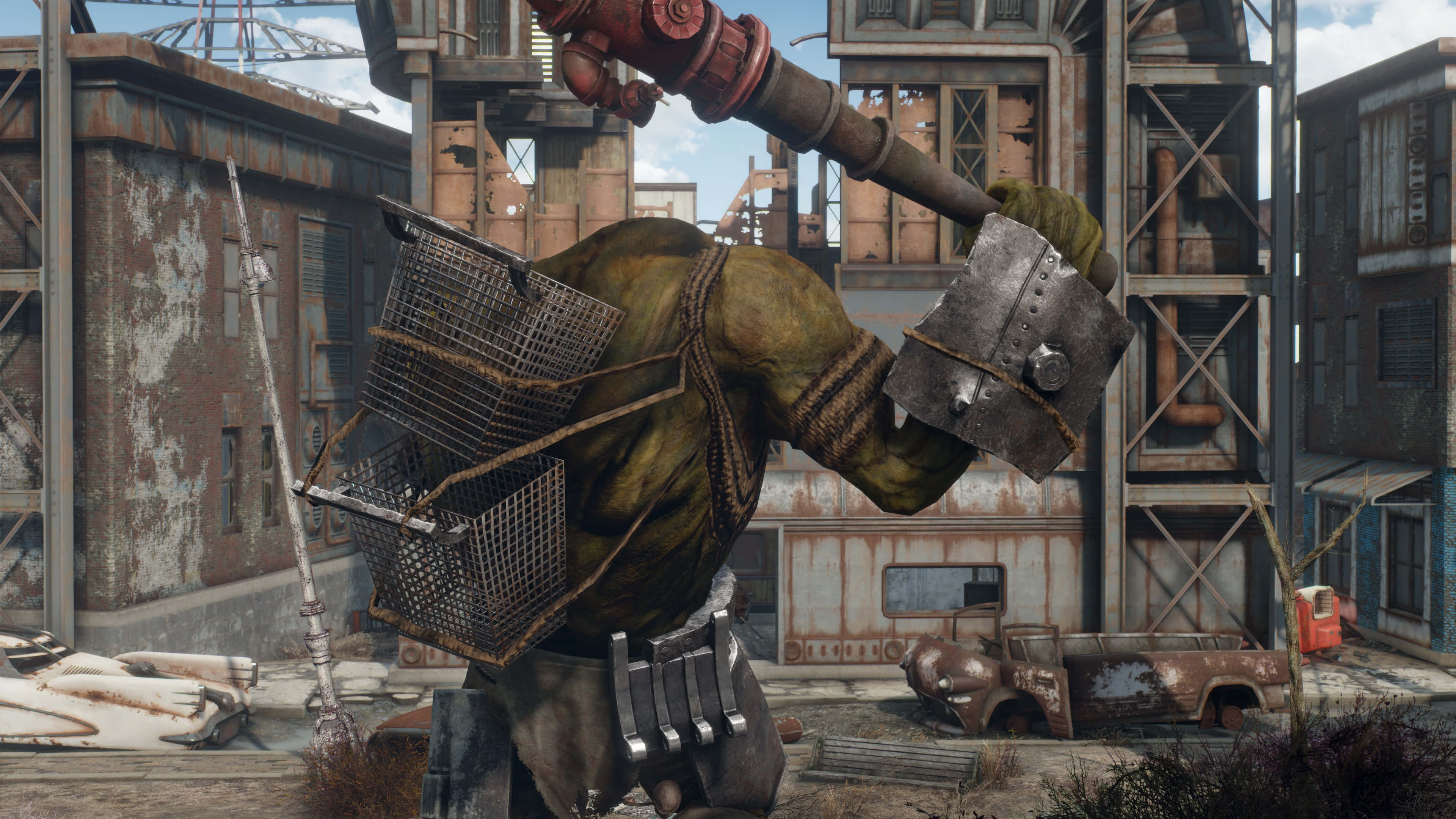 Fallout 4 The Capital Wasteland 桌布 壁紙 — 一個綠色皮膚的變種人在一個破敗的工業廢墟中揮舞著巨大的管道錘，周圍是生鏽的建築物和廢棄的車輛。
