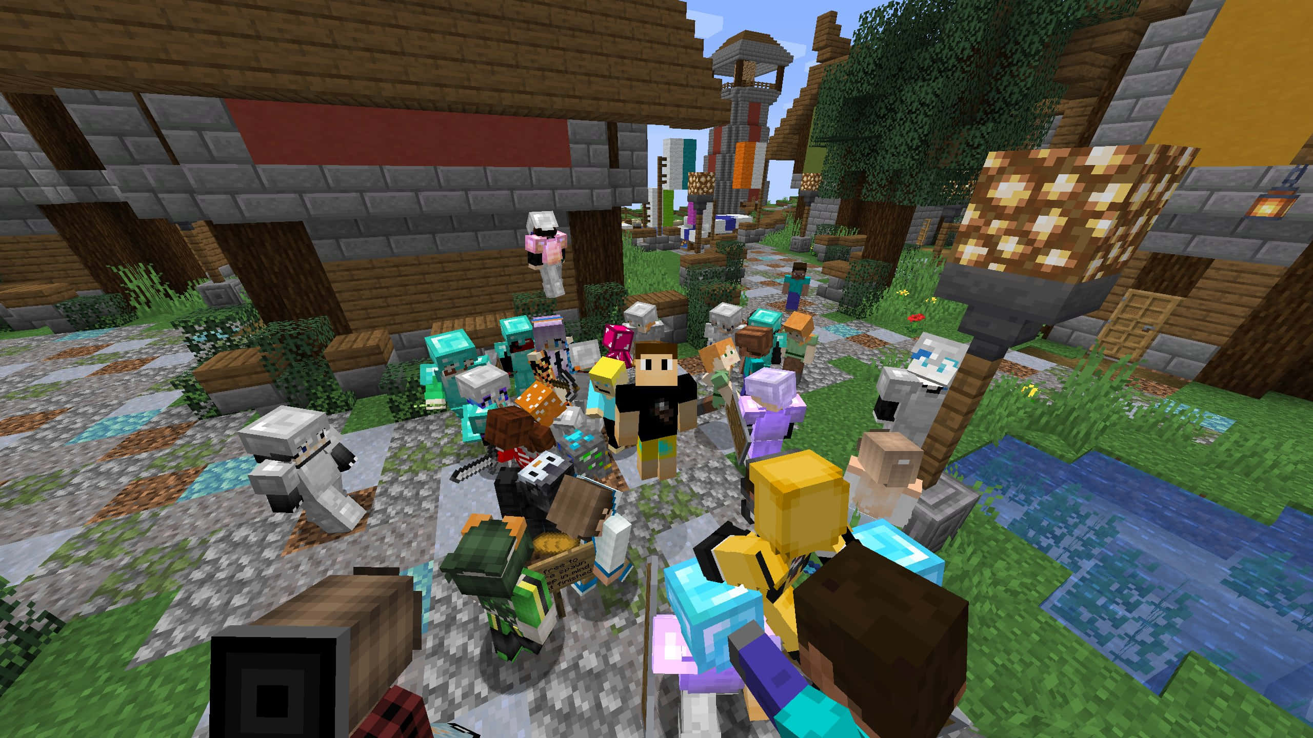 Minecraft Server 桌布 壁紙 — 一個繁忙的Minecraft村莊場景，像素化的村民和玩家聚集在木屋和小溪附近，在明亮的日光下。