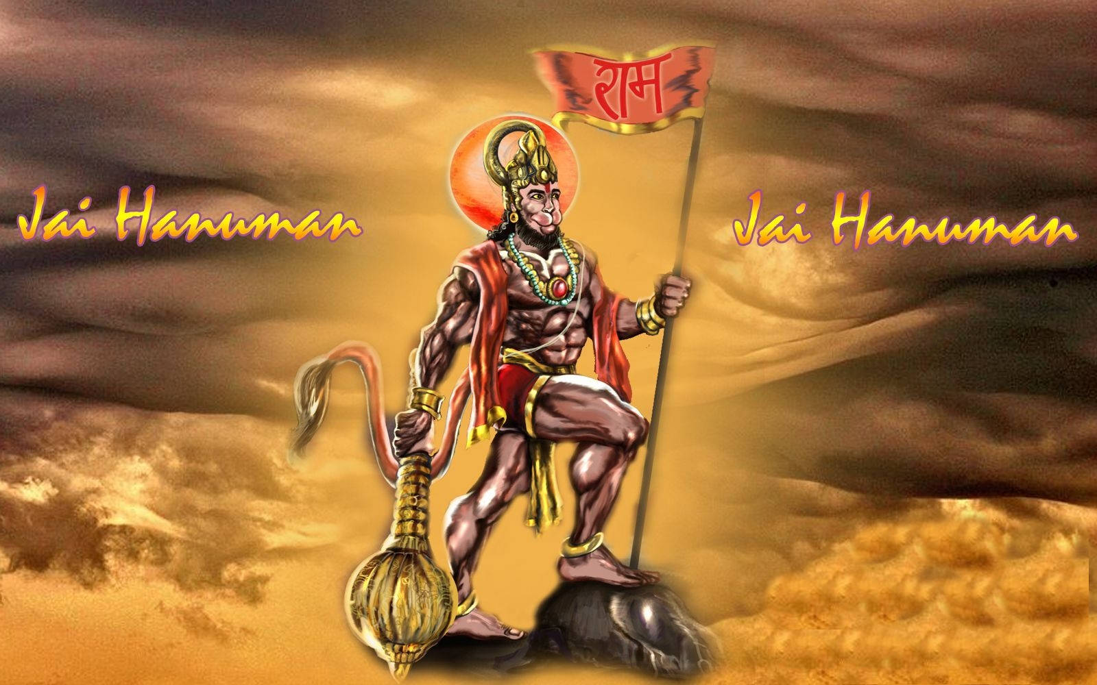 Hanuman 桌布 壁紙 — 一個肌肉發達嘅哈努曼企喺岩石上，手持旗幟同狼牙棒，背景係金色風暴天空，上面有「Jai Hanuman」字樣。