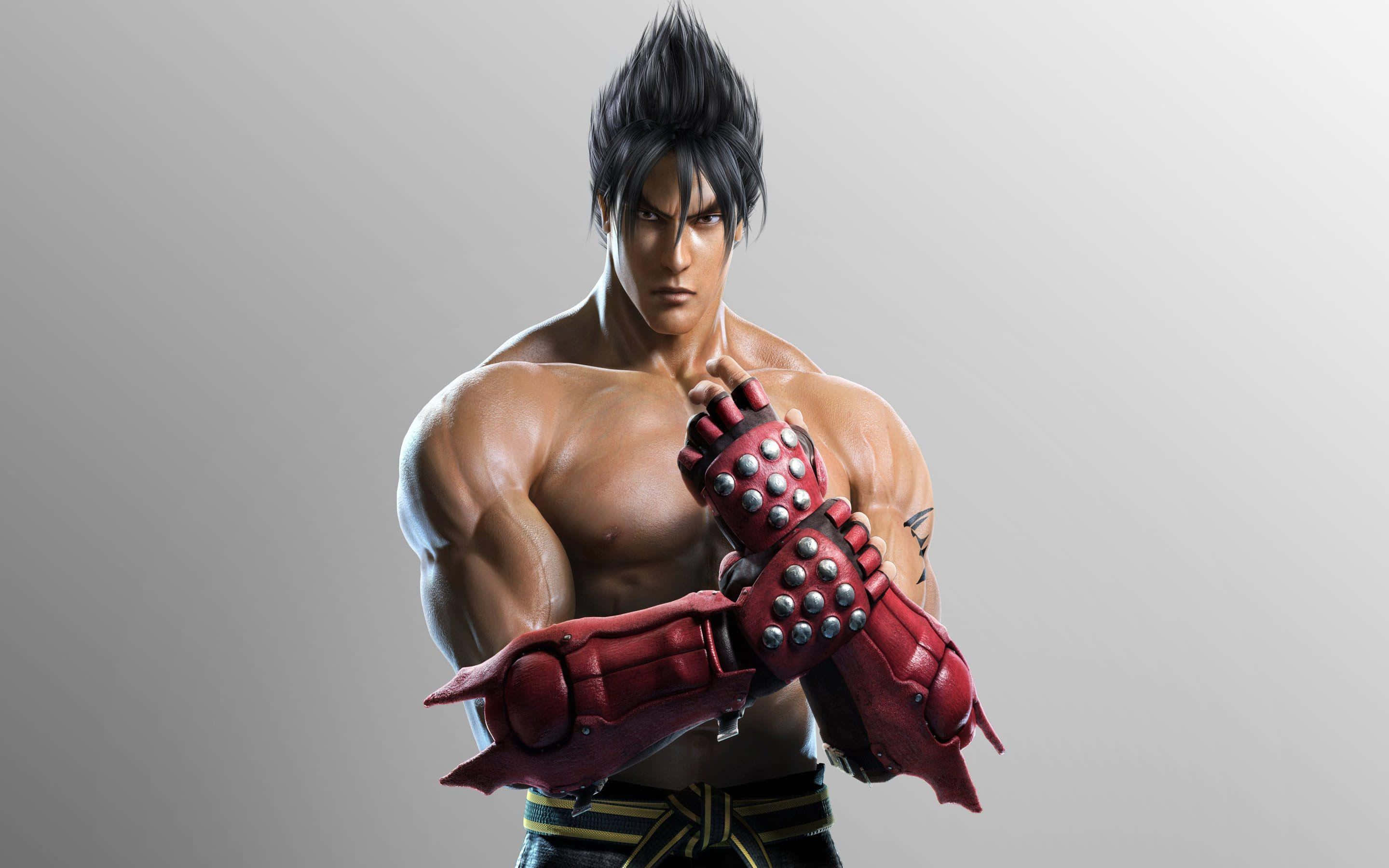 Tekken Characters 桌布 壁紙 — 一個肌肉發達的動漫戰士，擁有尖刺黑髮和紅色尖刺護手，在純灰色背景前擺出強烈的姿勢。