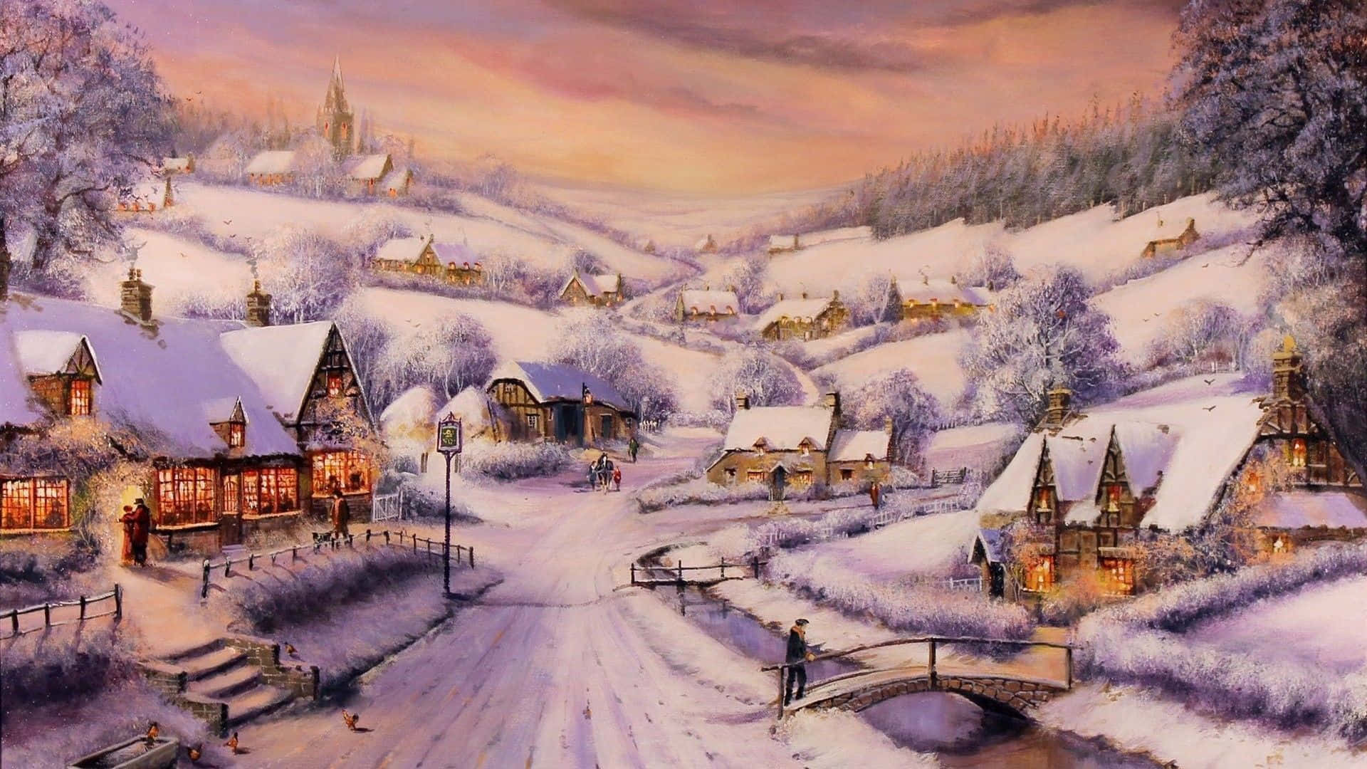 Snowy Village 桌布 壁紙 — 一個被雪覆蓋的村莊坐落在冬季的山丘中，窗戶閃爍著光芒，一座橋橫跨結冰的小溪，天空呈現柔和的粉紅色和橙色。