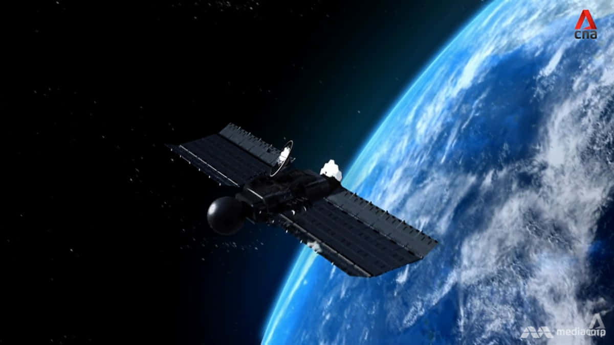 Satellite Technology 桌布 壁紙 — 一個詳細的衛星環繞地球運行，展示藍色海洋和白色雲朵，背景是太空的漆黑。