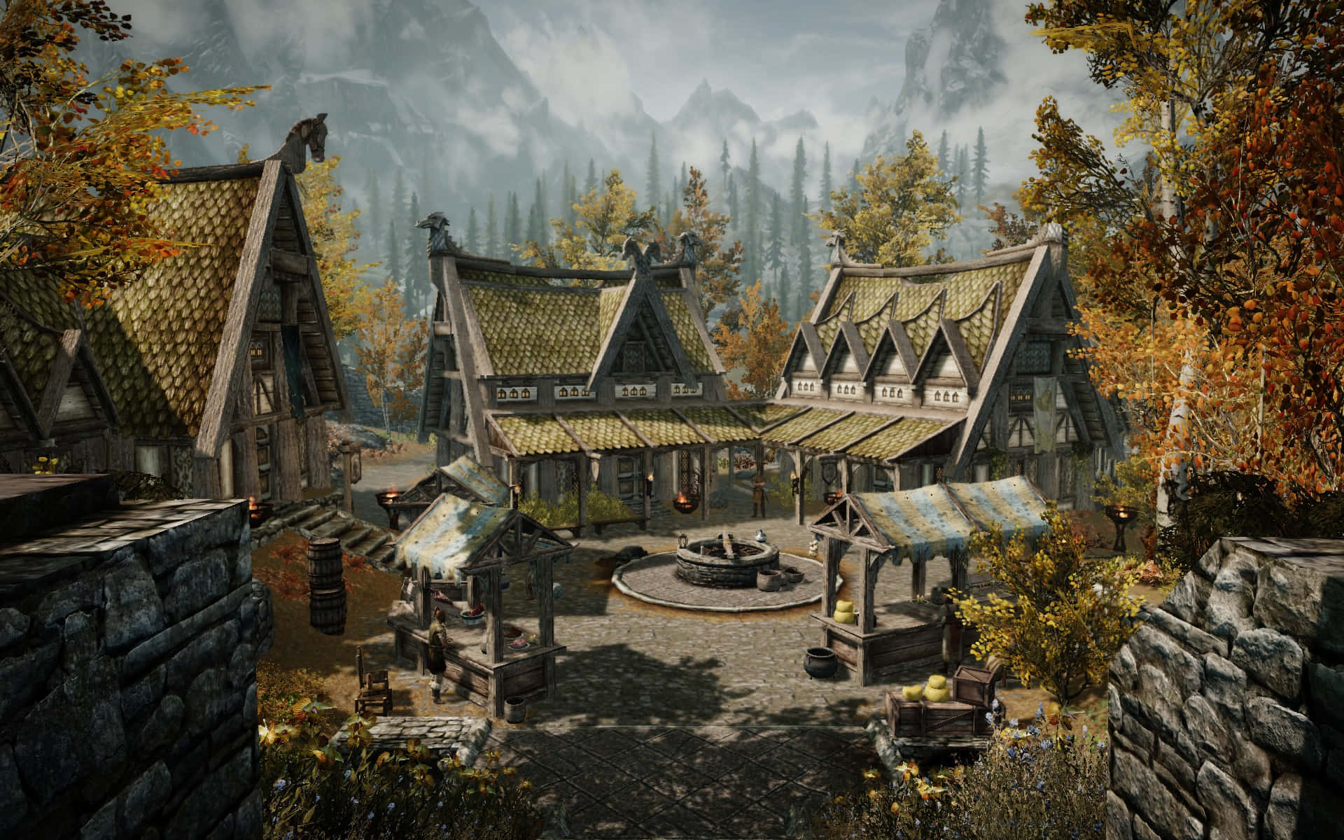 Skyrim Whiterun 桌布 壁紙 — 一個質樸的中世紀村莊，坐落在秋日樹林中，有石頭小屋和中央水井，天空多雲。