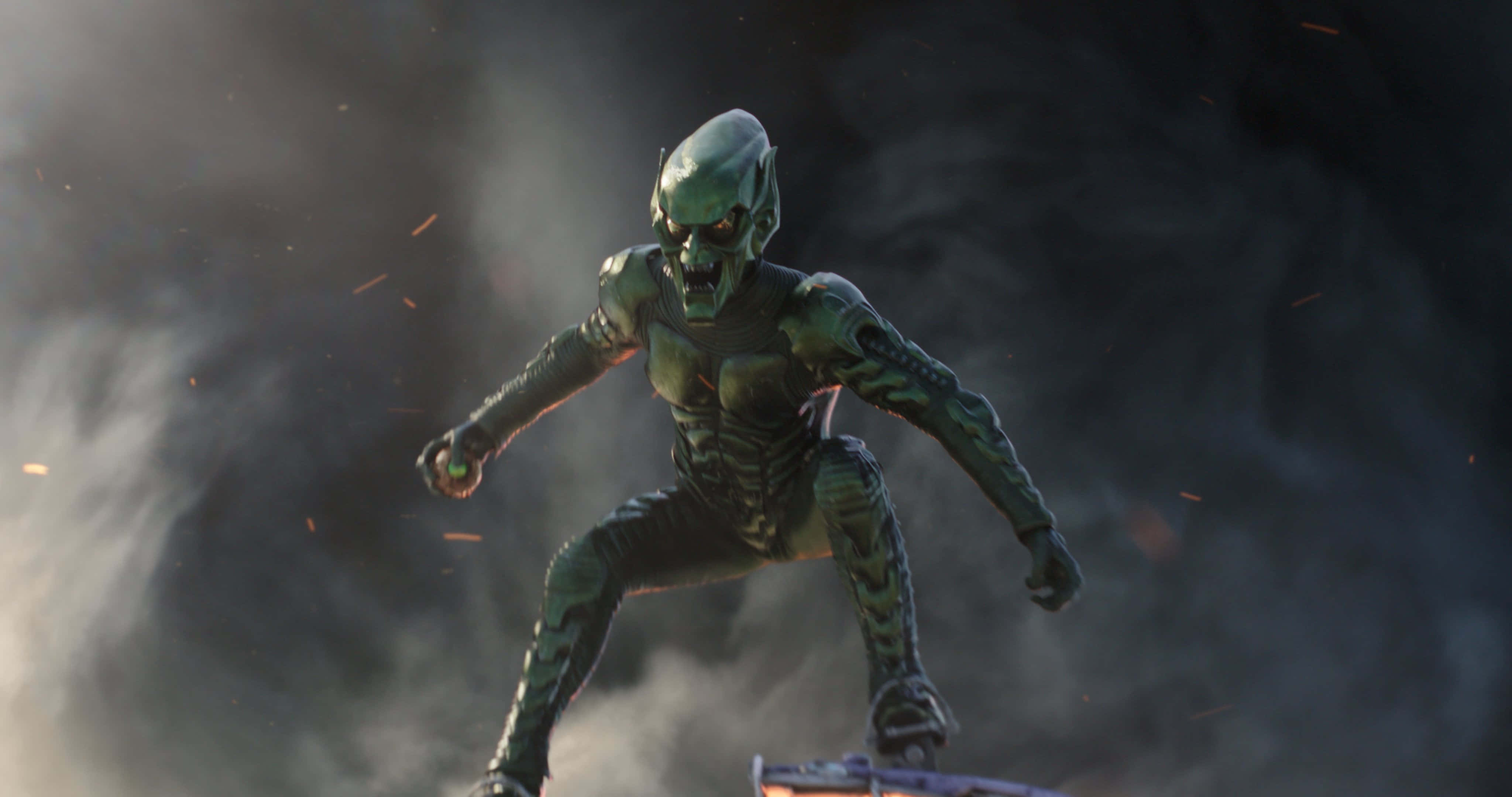 Norman Osborn 桌布 壁紙 — 一個身穿裝甲服、綠色皮膚的威脅性外星戰士在黑暗戰場上，於煙霧和火花中向前猛衝。