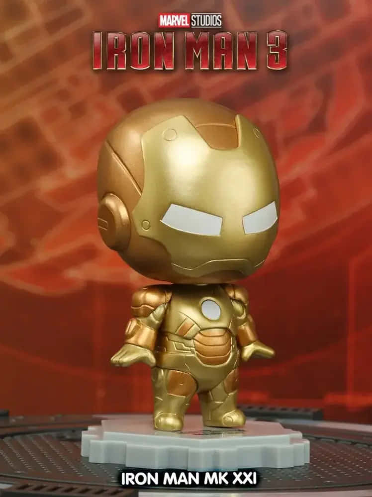 Iron Man Bobbleheads 桌布 壁紙 — 一個金色嘅 Iron Man MK XXI Q版公仔企喺灰色底座上，背景係紅色紋理，帶有 'Iron Man 3' 品牌標誌。
