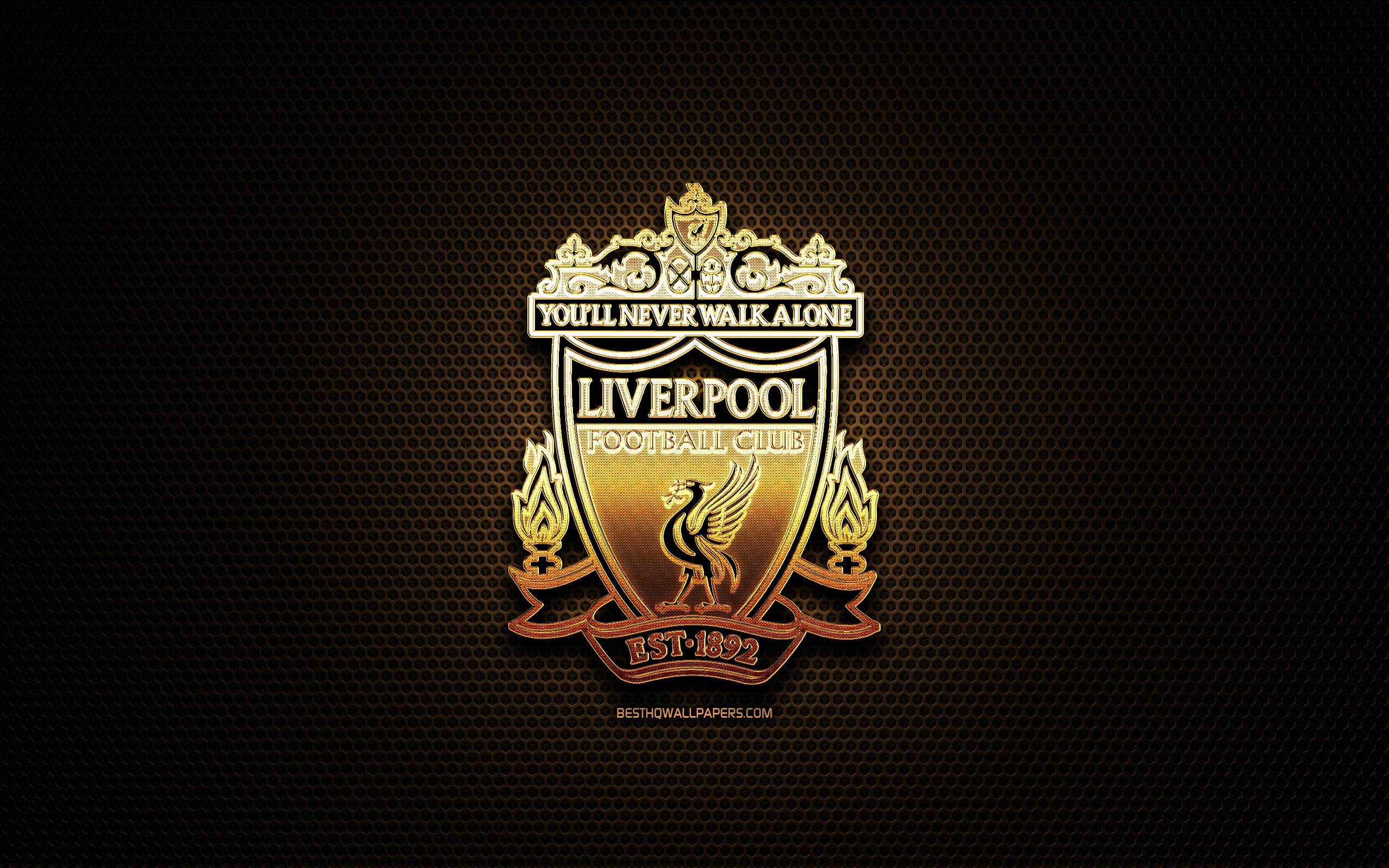 Liverpool Fc 桌布 壁紙 — 一個閃閃發光的金色利物浦足球會徽章，置中在帶有火焰效果的深色紋理背景上。