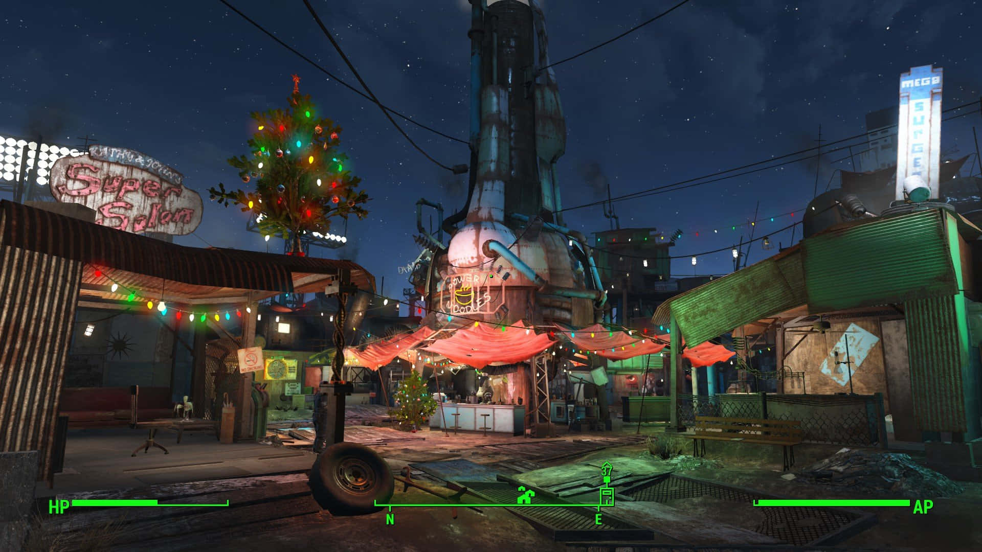 Diamond City 桌布 壁紙 — 一個霓虹燈照亮嘅末世小鎮廣場夜晚，有一個裝飾咗嘅聖誕樹喺星空下發光。