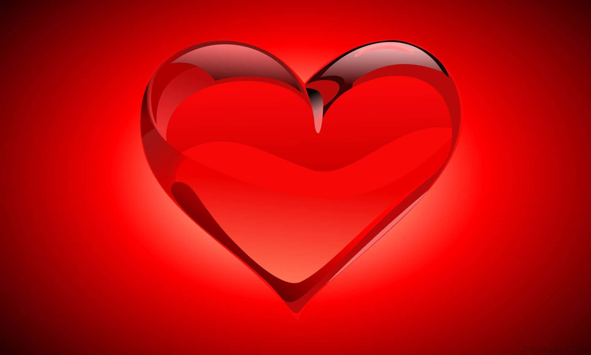 Red Heart 桌布 壁紙 — 一個頂部破裂的光澤紅色心形在耀眼的紅色漸變背景上發光。