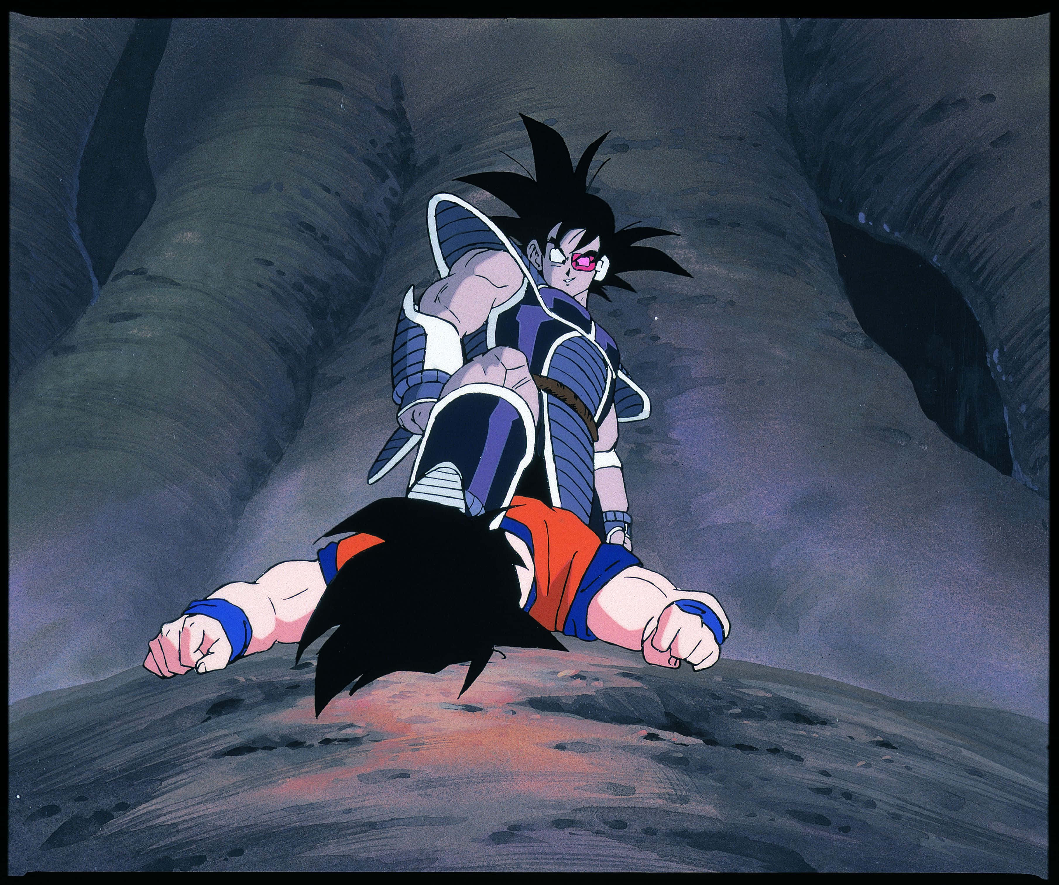 Dbz Movies 桌布 壁紙 — 一個頭髮尖刺的動漫戰士穿著藍色盔甲，在黑暗洞穴內的岩石地面上蹲伏，雙腳發出紅色光芒。