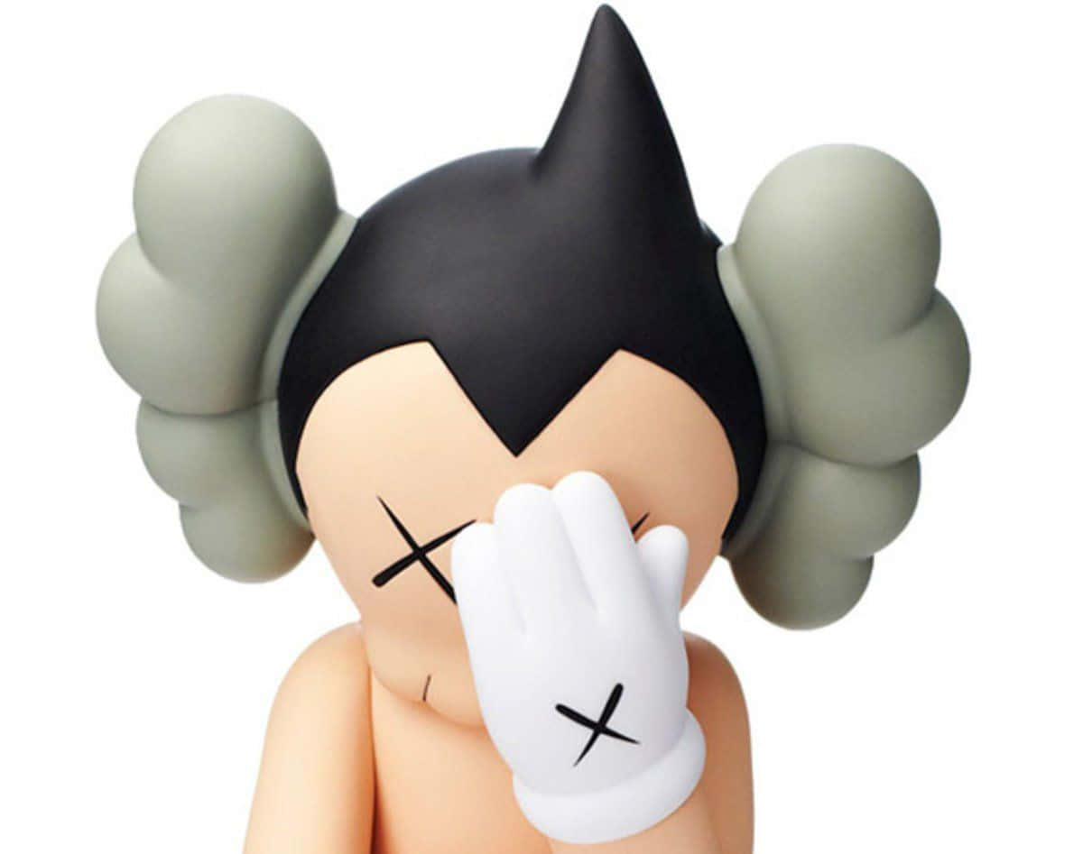 Kaws Astro Boy 桌布 壁紙 — 一個風格化人偶，黑色尖刺頭髮，灰色絨球遮住耳朵，X形眼睛，用戴白色手套的手遮住臉。