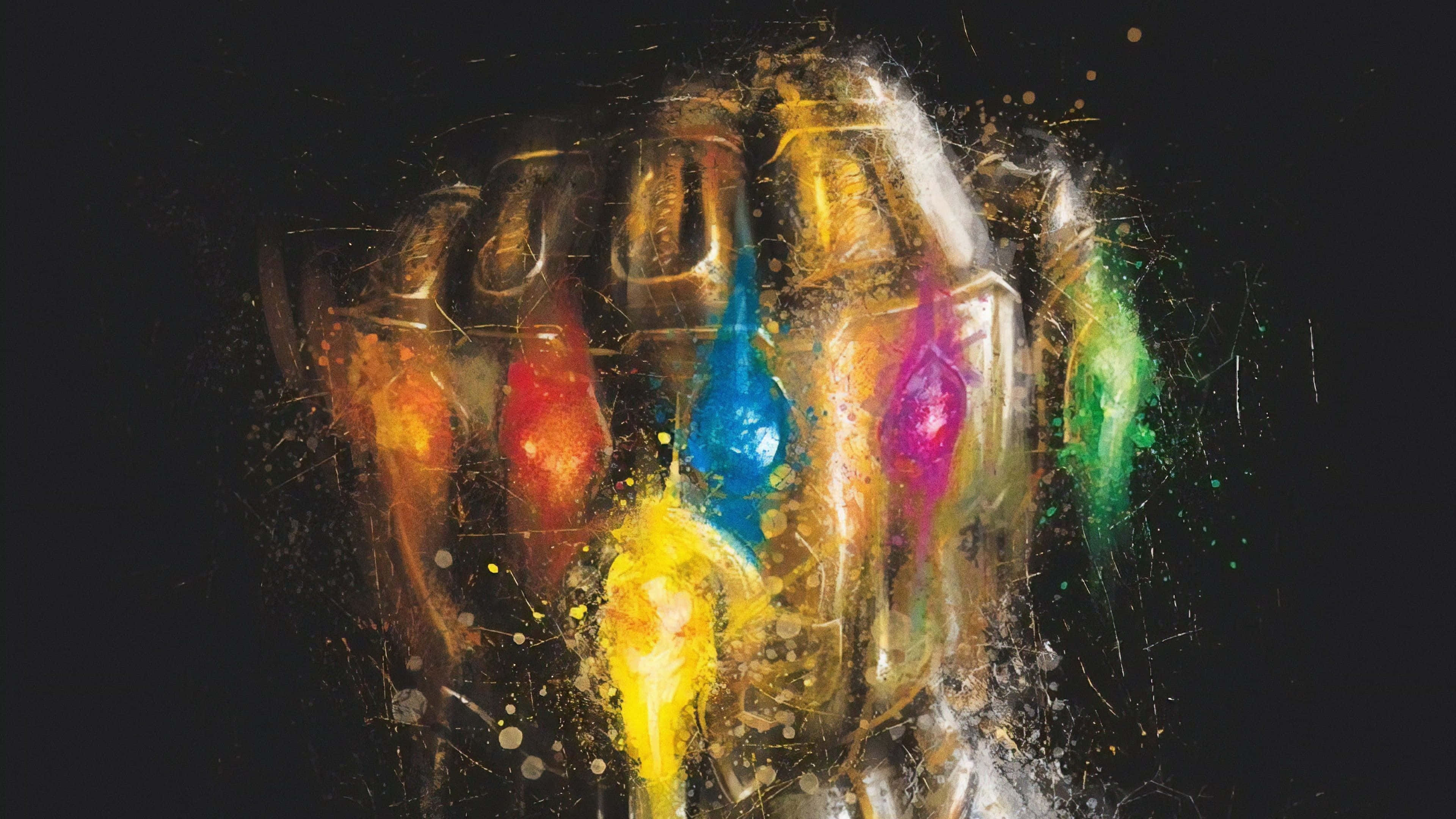 Infinity Gems 桌布 壁紙 — 一個風格化的金色手套，上面有六顆色彩繽紛的發光寶石，濺在深色背景上。