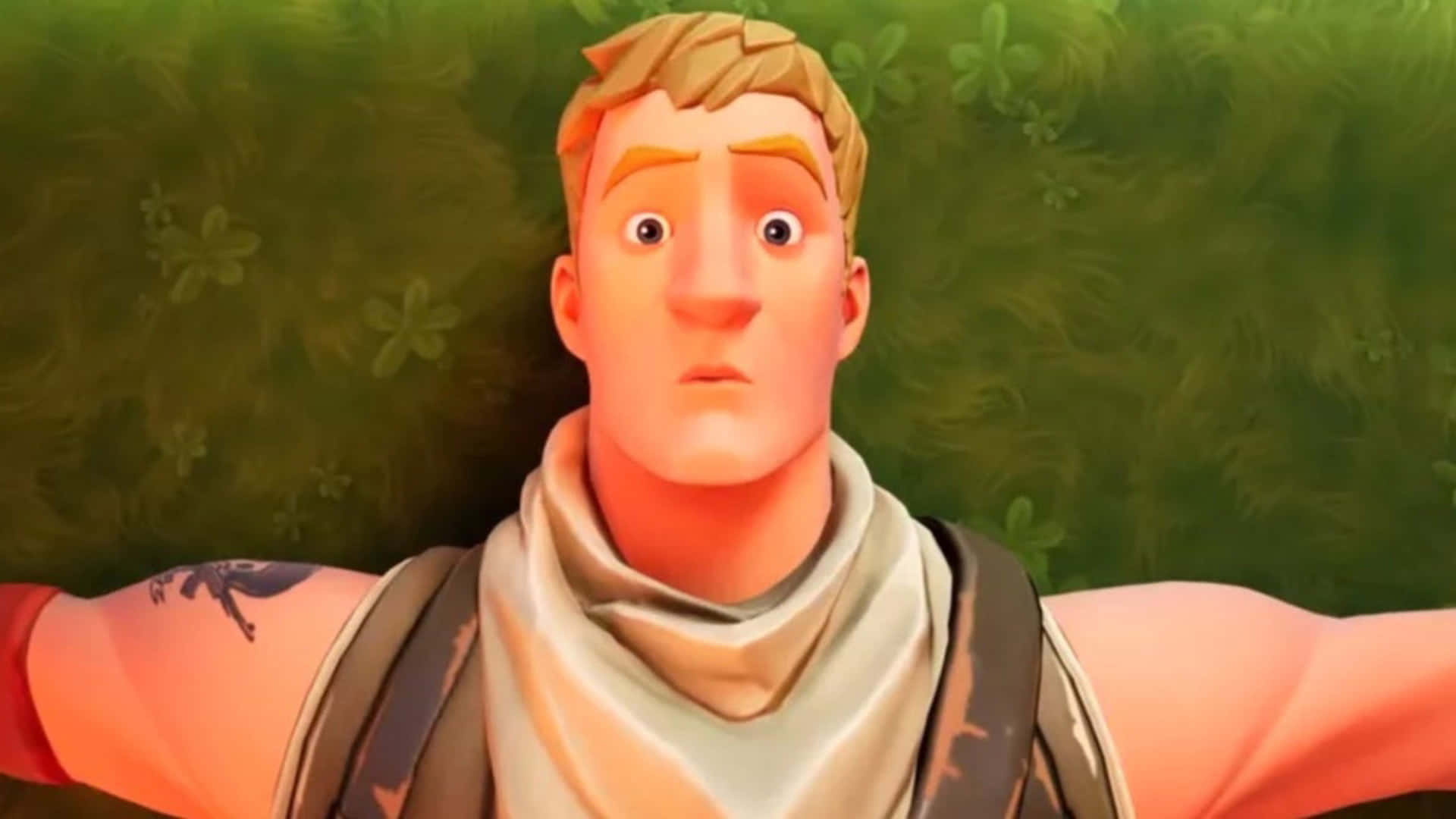 Jonesy Fortnite 桌布 壁紙 — 一個驚訝的動畫男性角色，金髮並有紋身，睜大眼睛躺在草地上。