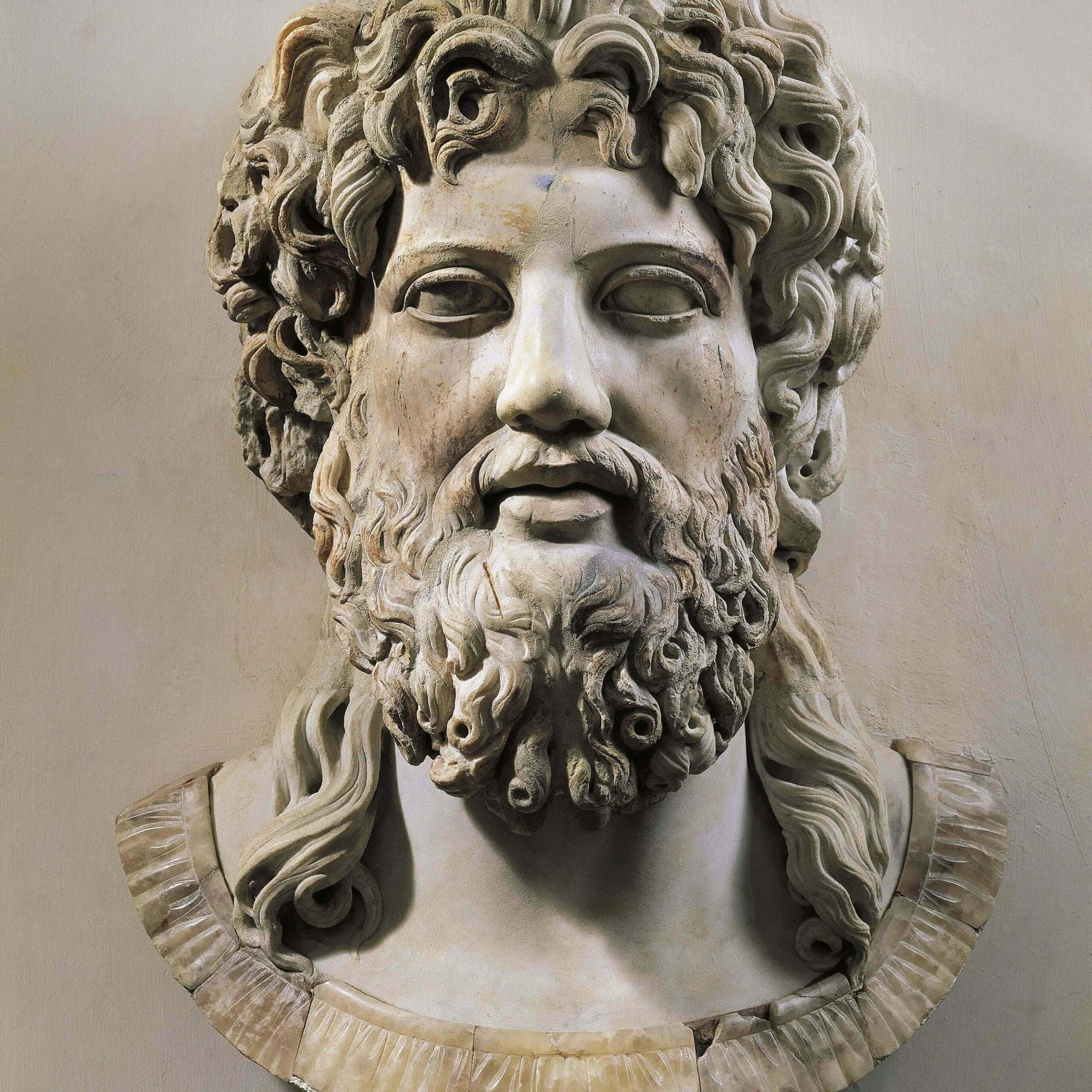 greek 桌布 壁紙 — 一個鬍鬚男子嘅風化大理石半身像，有曲髮同平靜表情，由垂褶領圍住。