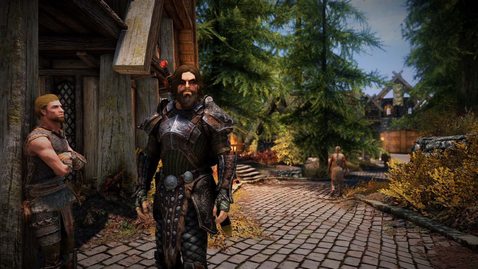 dovahkiin 桌布 壁紙 — 一個鬍鬚裝甲戰士站在鵝卵石小徑上，身處一個被高樹和木建築環繞的鄉村村莊。