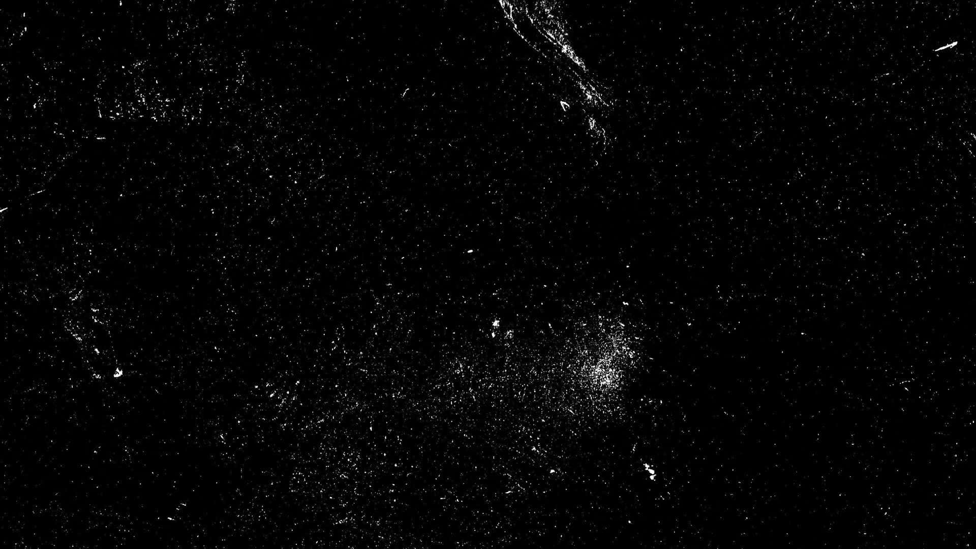 Dark Grunge 桌布 壁紙 — 一個鮮明的黑色表面，帶有散落的白色斑點和條紋，類似宇宙塵埃或抽象刮痕。