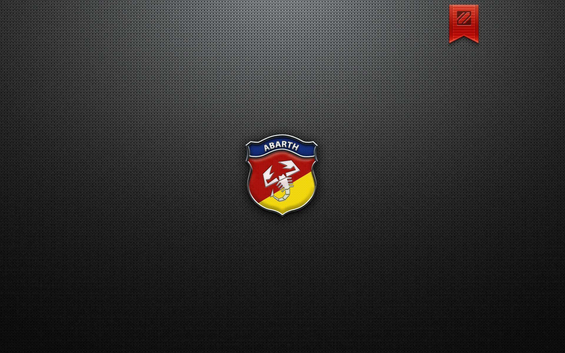 Abarth 桌布 壁紙 — 一個鮮豔的Abarth標誌徽章居中在深色紋理背景上，角落有一個紅色絲帶徽章。