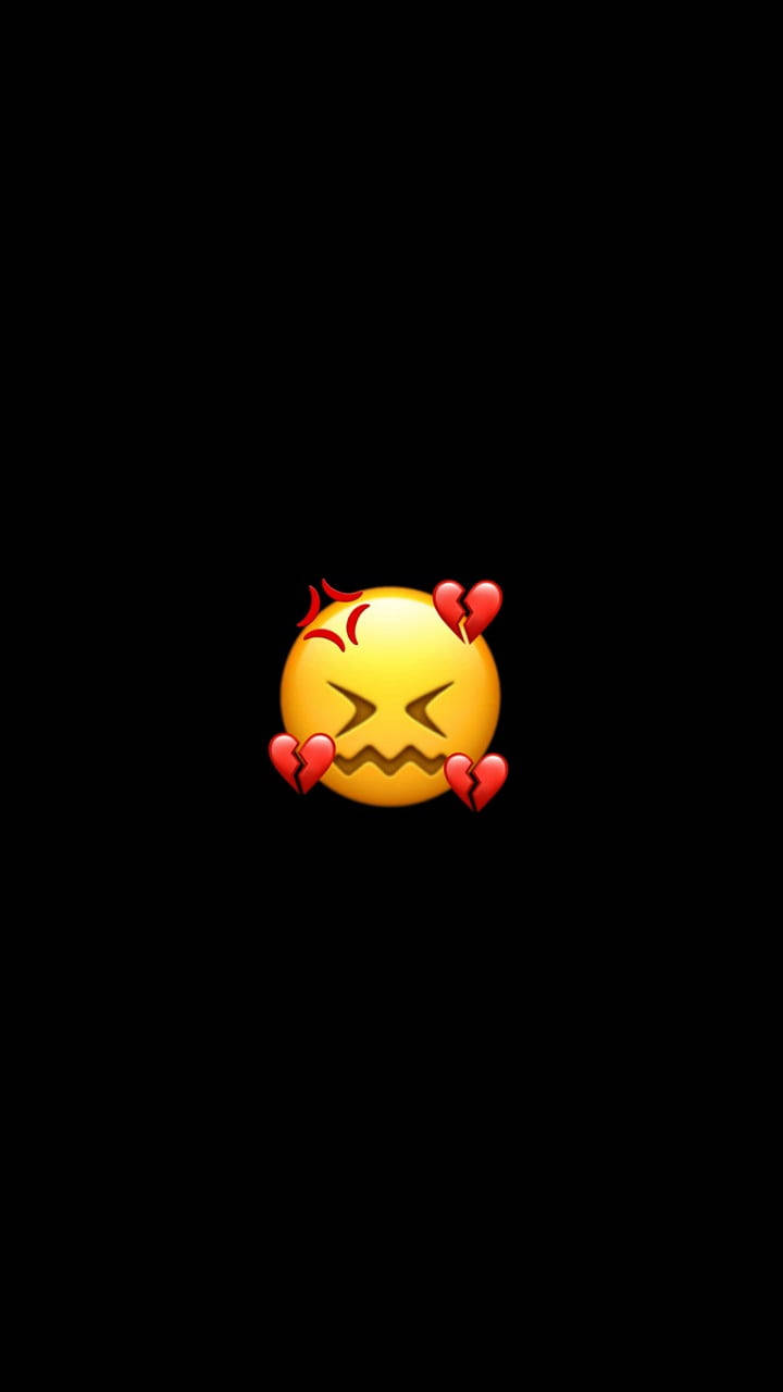 Black Emoji 桌布 壁紙 — 一個黃色表情符號，帶有憤怒的眼睛，周圍有破碎的心，背景為黑色。
