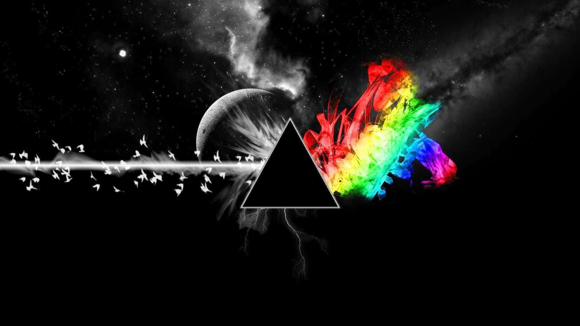  壁紙 — 一個黑色三角形將宇宙場景一分為二，左邊有單色行星和飛鳥，右邊有充滿活力的彩虹能量爆發。