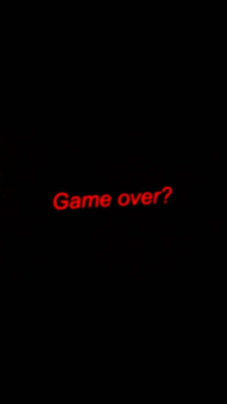 Dark Game Over 桌布 壁紙 — 一個黑色屏幕，帶有發光的紅色文字，以復古電子遊戲字體問「Game over？」。