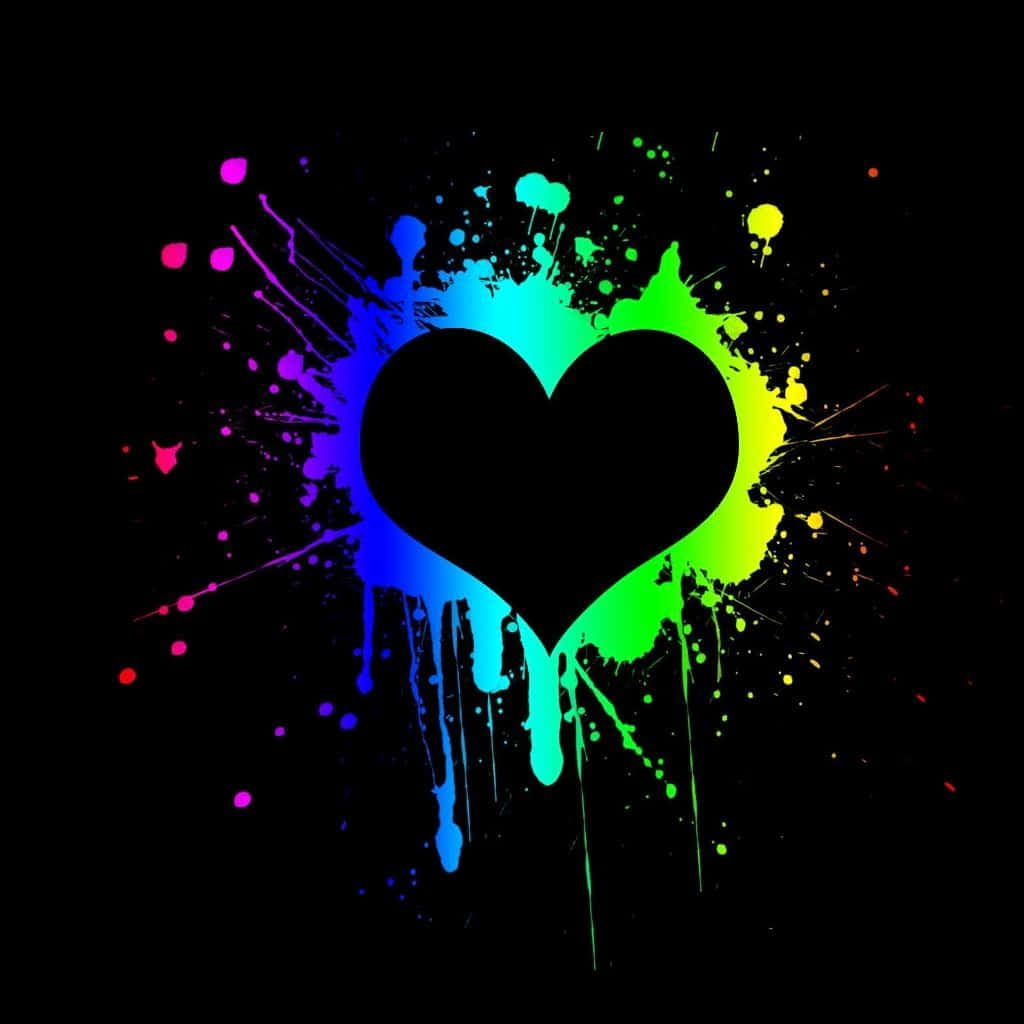 Broken Heart Black 桌布 壁紙 — 一個黑色心形剪影在深色背景上爆發出充滿活力的彩虹顏料飛濺。