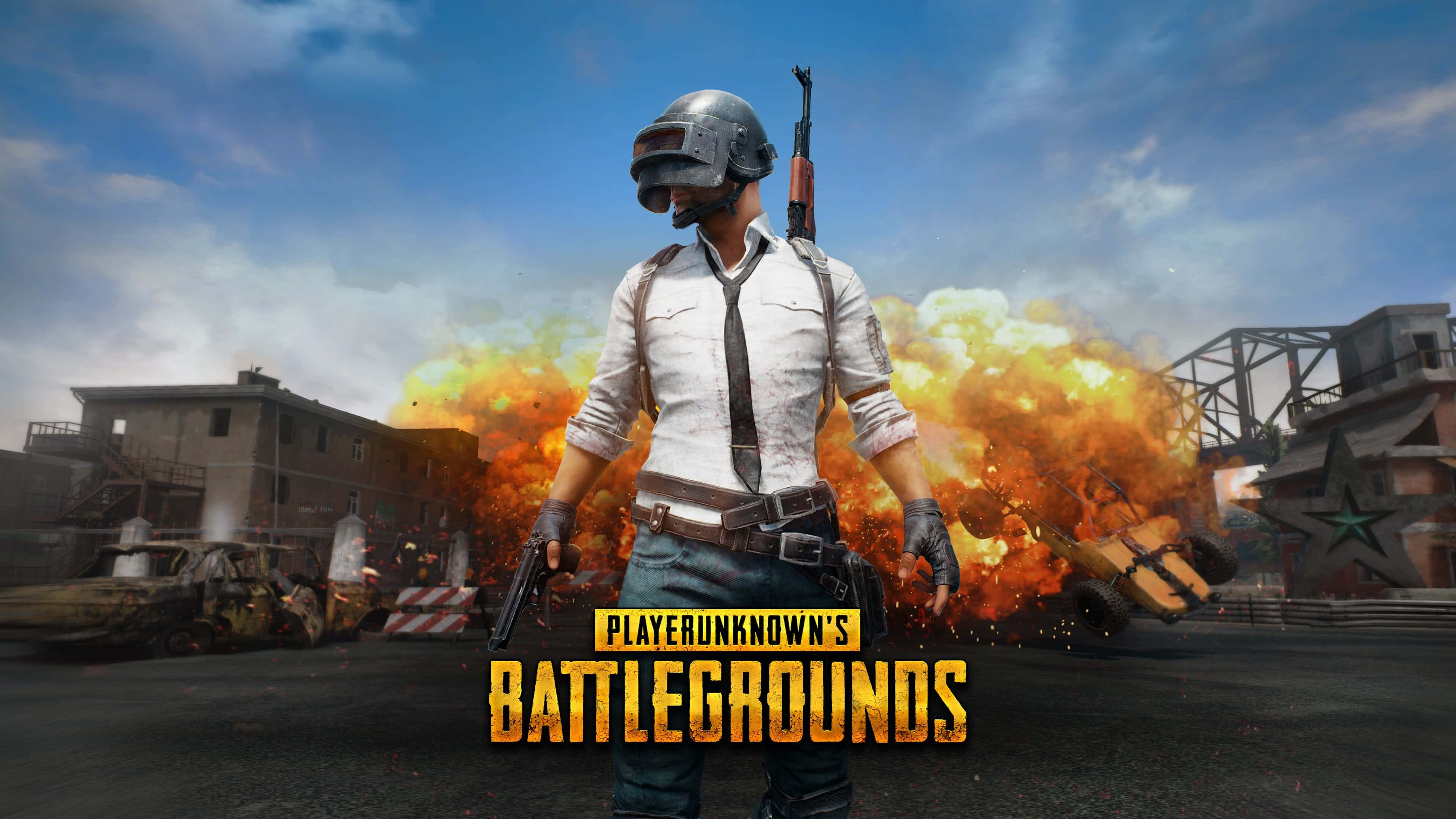Pubg Logo 桌布 壁紙 — 一名戴頭盔和領帶的士兵站在廢墟般的城市戰場中，身處猛烈爆炸之中，並帶有遊戲標誌。