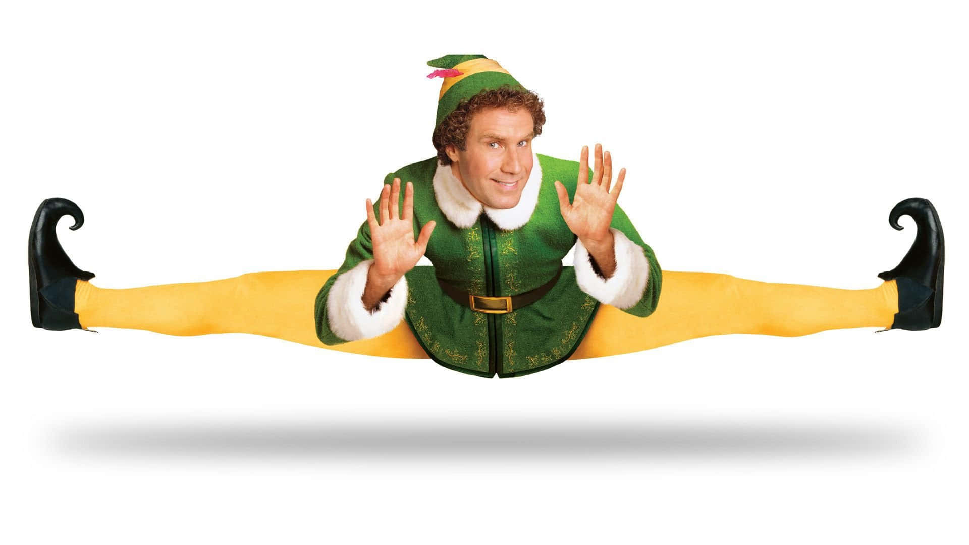 Christmas Movie 桌布 壁紙 — 一名穿著綠色精靈服裝的男子在白色背景上做出劈腿動作，表情俏皮。