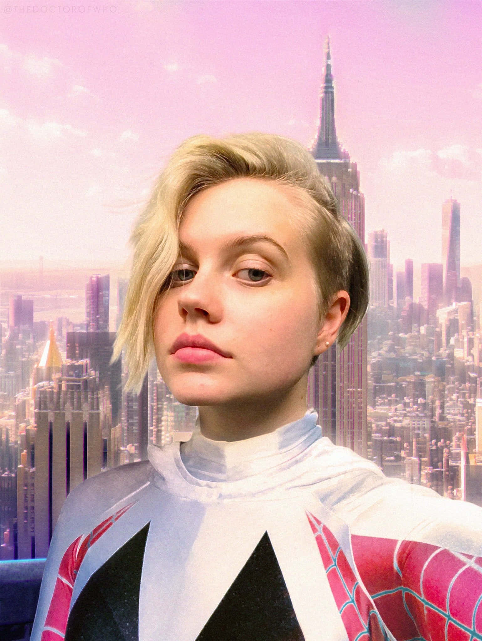 Betty Brant 桌布 壁紙 — 一名穿著蜘蛛俠服裝的人士在粉紅色調的紐約市天際線（包括帝國大廈）前擺姿勢。