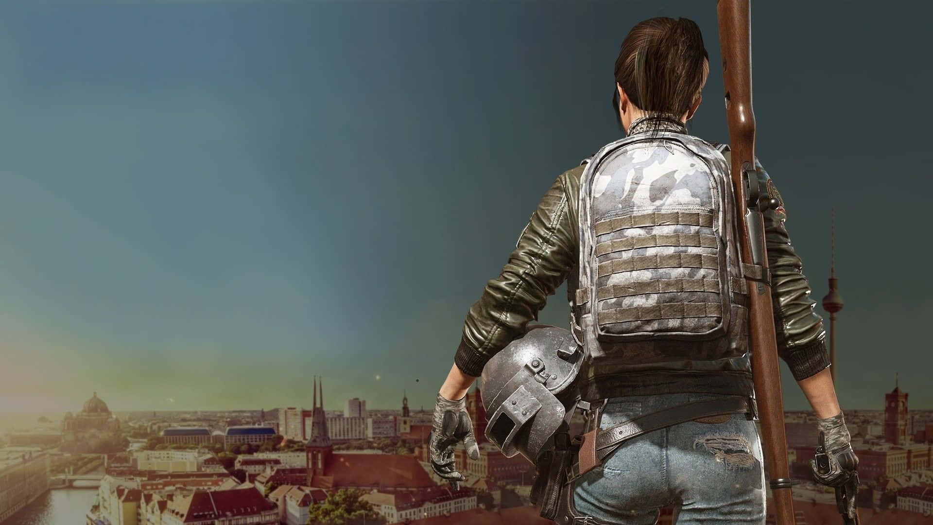 PUBG 桌布 壁紙 — 一名身穿戰術裝備的士兵站在建築物頂部，俯瞰黃昏時分廣闊的城市景觀。