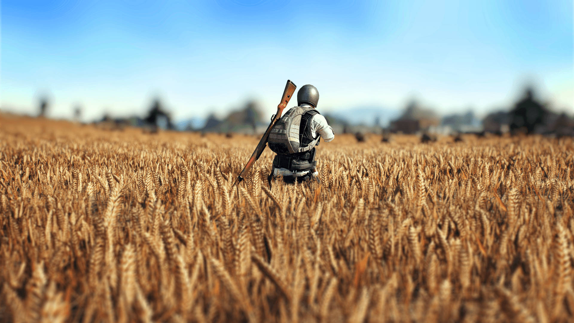 PUBG 桌布 壁紙 — 一名身穿戰鬥裝備的士兵在晴朗的藍天下走過金色的麥田。