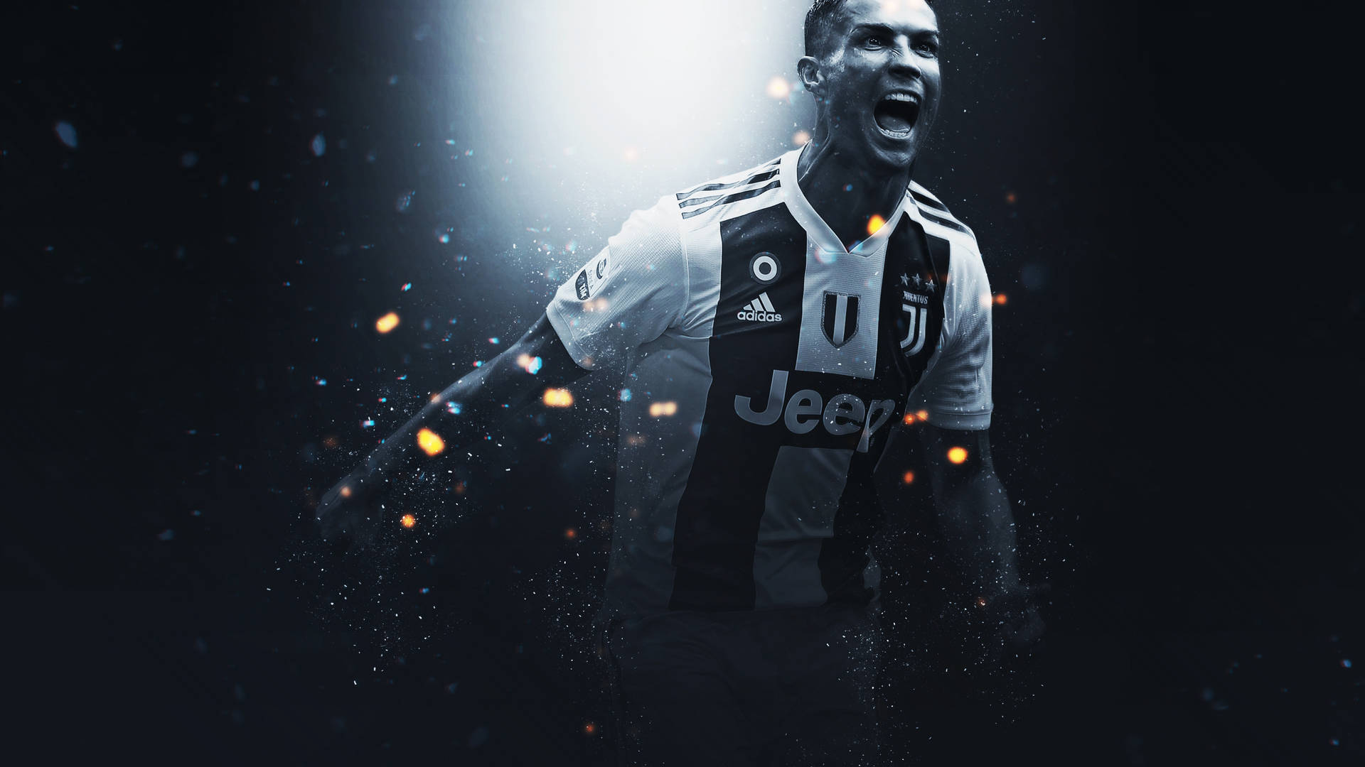 Ronaldo 桌布 壁紙 — 一名身穿祖雲達斯球衣的足球運動員在黑暗背景中，伴隨著發光粒子和戲劇性燈光，發出勝利的咆哮。