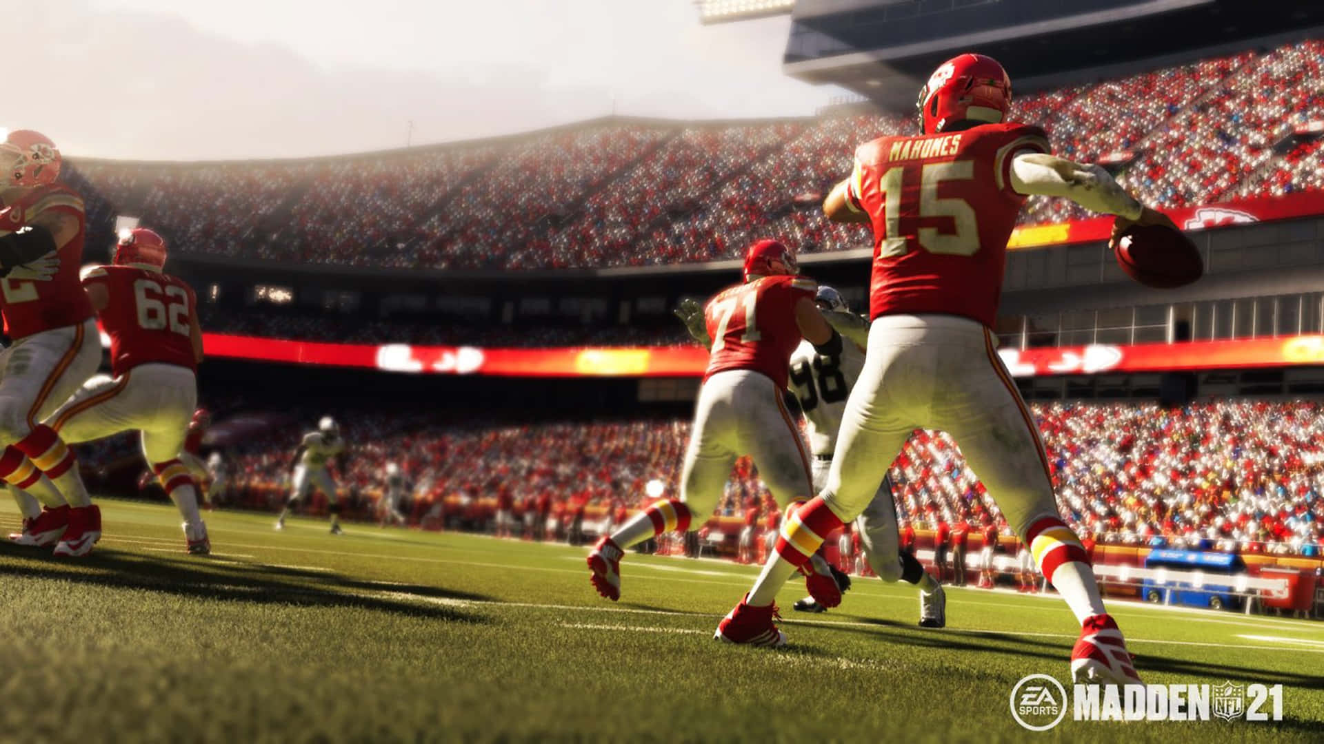 Madden NFL 22 桌布 壁紙 — 一名身穿紅色15號球衣的美式足球四分衛在陽光明媚的日間比賽中，於座無虛席的體育館內傳球。