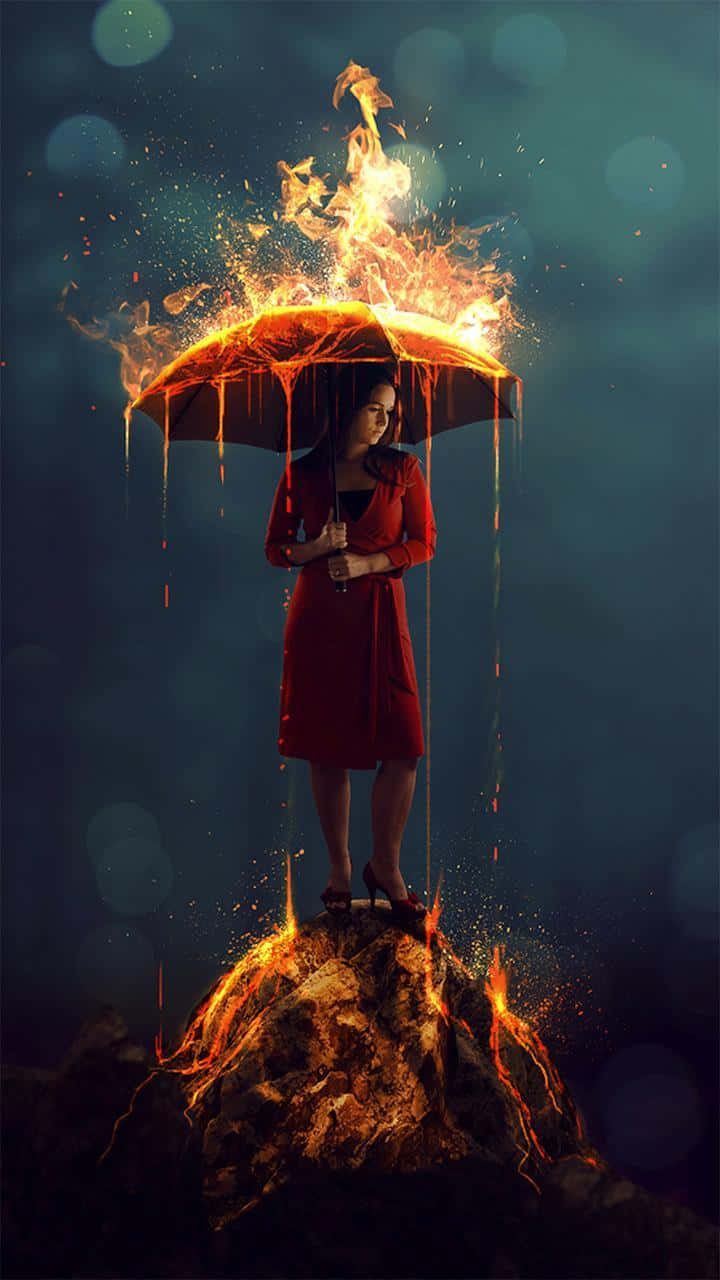 Flames 桌布 壁紙 — 一名身穿紅色連衣裙的女子站在燃燒的岩石上，手持一把燃燒著橙色火焰、滴落餘燼的雨傘，背景是深藍綠色的散景。