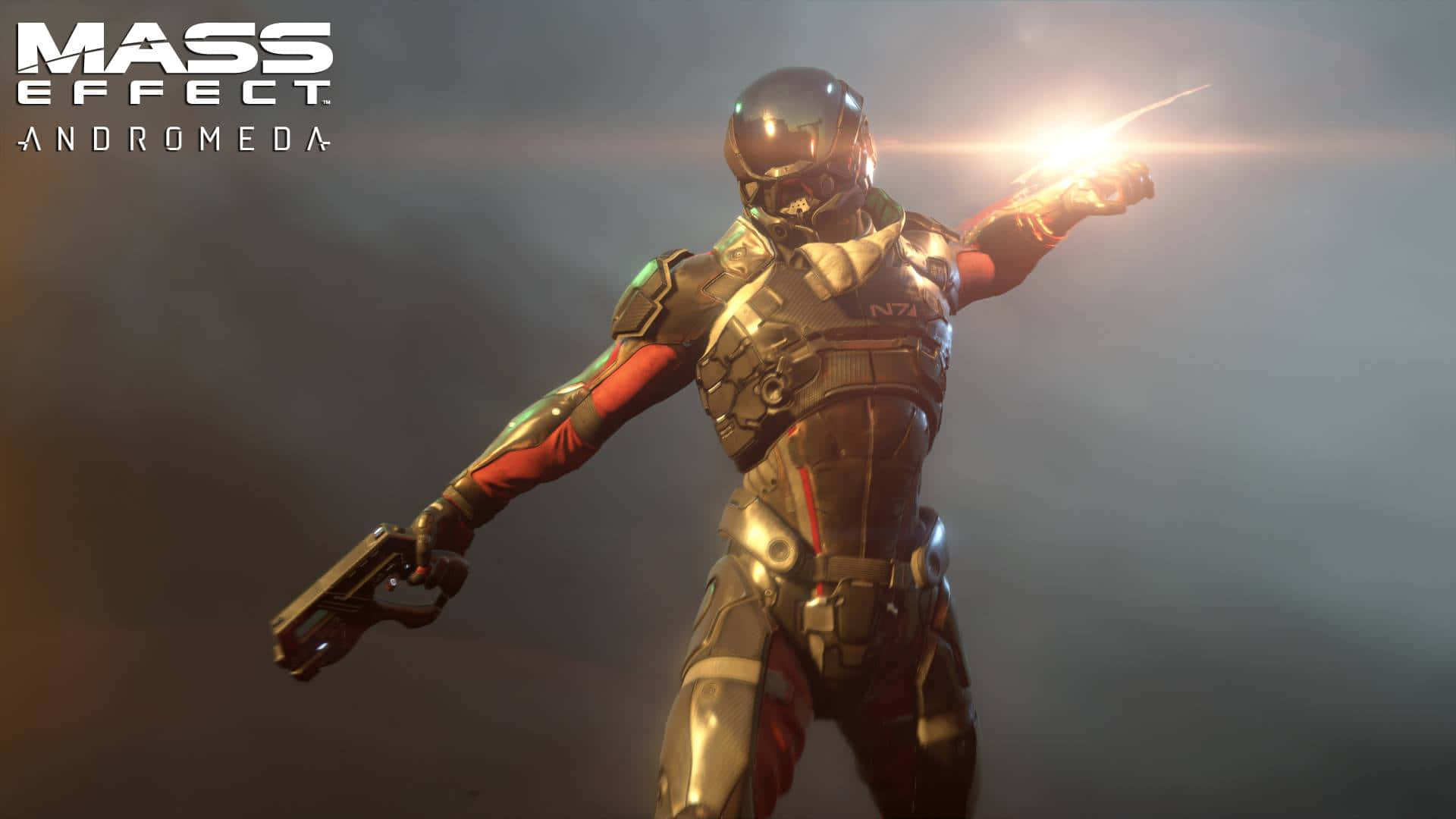 Mass Effect Andromeda 桌布 壁紙 — 一名身穿金屬盔甲的未来士兵在模糊的背景中發射發光武器，遊戲標題可見。