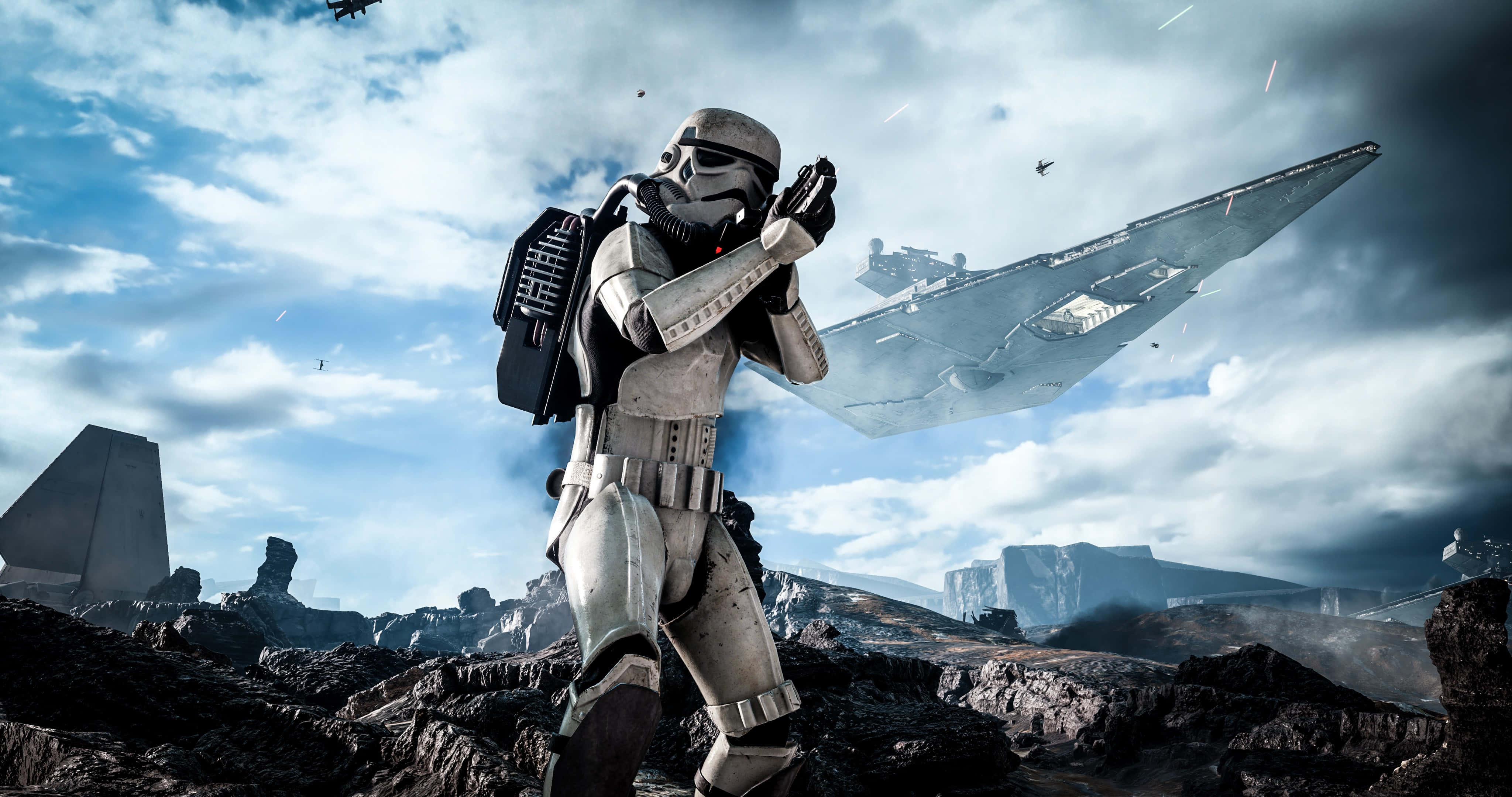 Star Wars Games 桌布 壁紙 — 一名風暴兵在岩石外星行星上保持警覺，而一艘星際毀滅者潛伏在陰雲密佈的天空中。