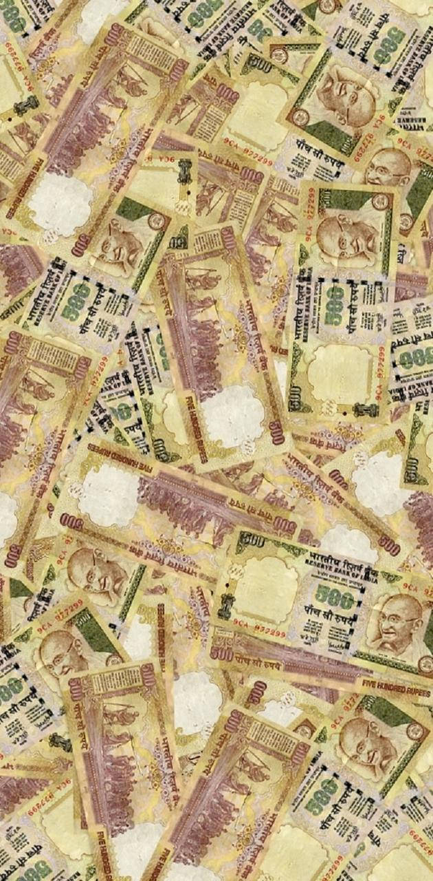 Indian 桌布 壁紙 — 一堆密集混亂的印度500盧比鈔票，以溫暖的黃色和綠色色調重疊在一起。