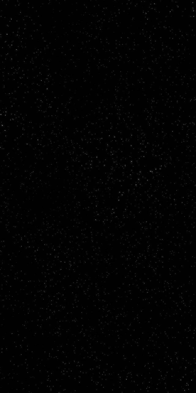 simple dark aesthetic 桌布 壁紙 — 一塊廣闊的黑色畫布上點綴著無數細小的白色星星，營造出深邃的宇宙夜空。