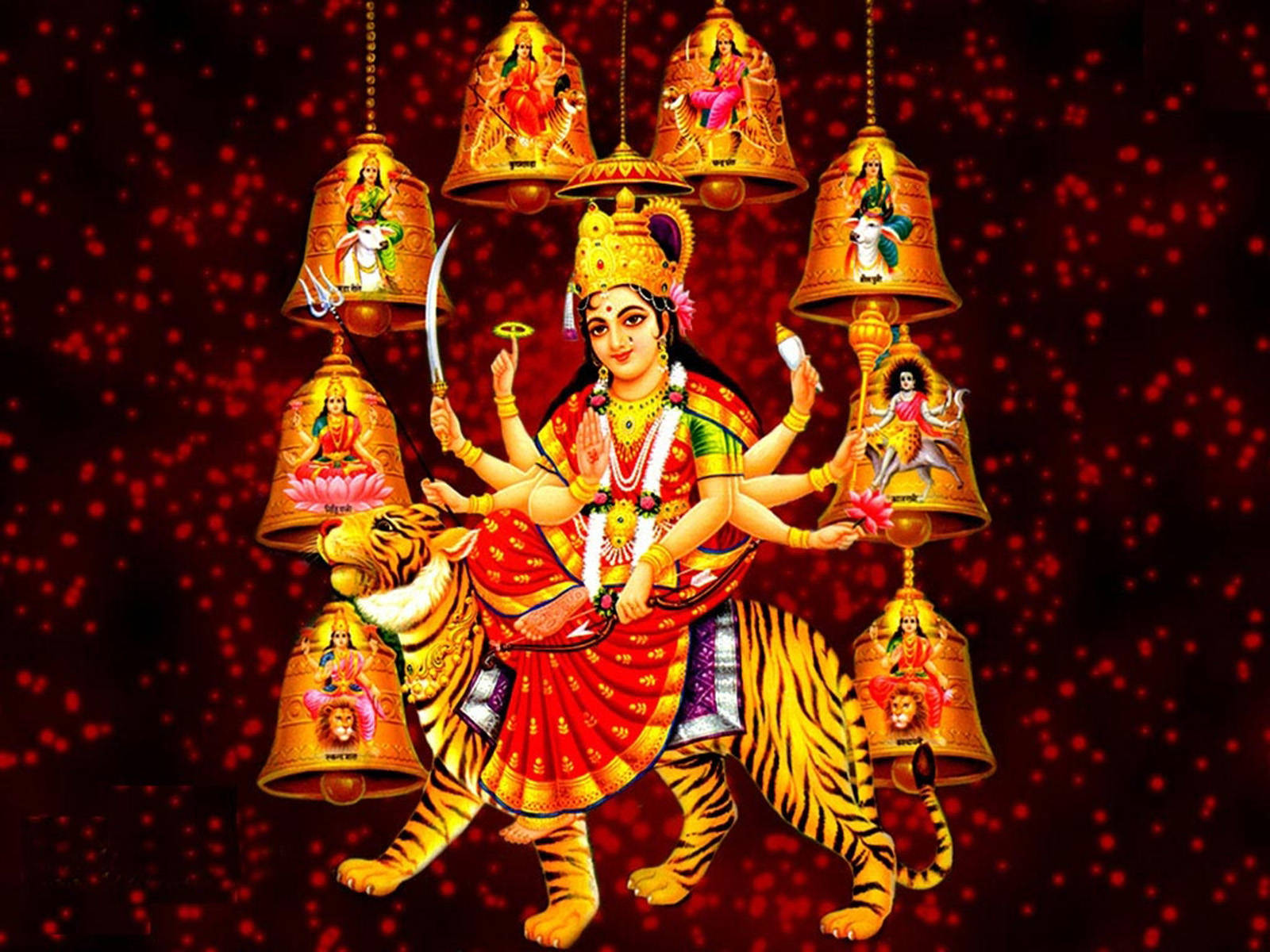Indian 桌布 壁紙 — 一幅充滿活力的插圖，描繪印度教女神杜爾迦騎著老虎，周圍環繞著金色鈴鐺，每個鈴鐺上都繪有一位神祇，背景是閃閃發光的紅色。
