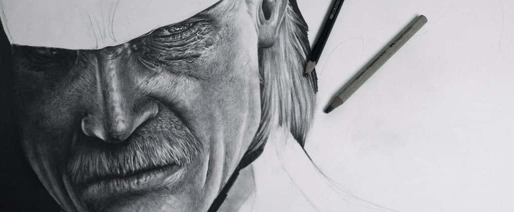 Charcoal Drawings 桌布 壁紙 — 一幅超寫實鉛筆素描，描繪一個神情嚴肅、眼神銳利、留鬍子的男人面孔，旁邊放著繪圖工具，畫在白紙上。