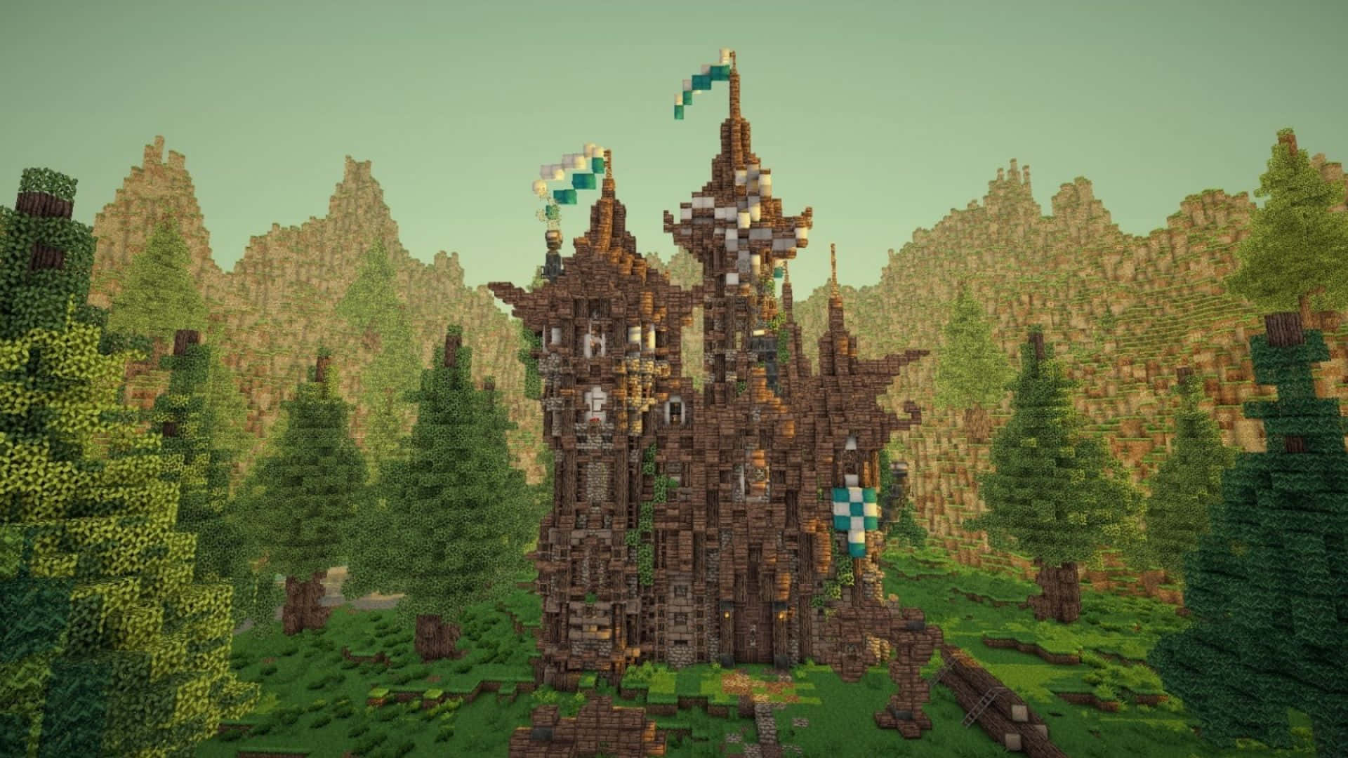 Best Minecraft 桌布 壁紙 — 一座像素化的Minecraft城堡，帶有藍色旗幟，矗立在森林中，周圍是鋸齒狀的山脈，天空柔和。