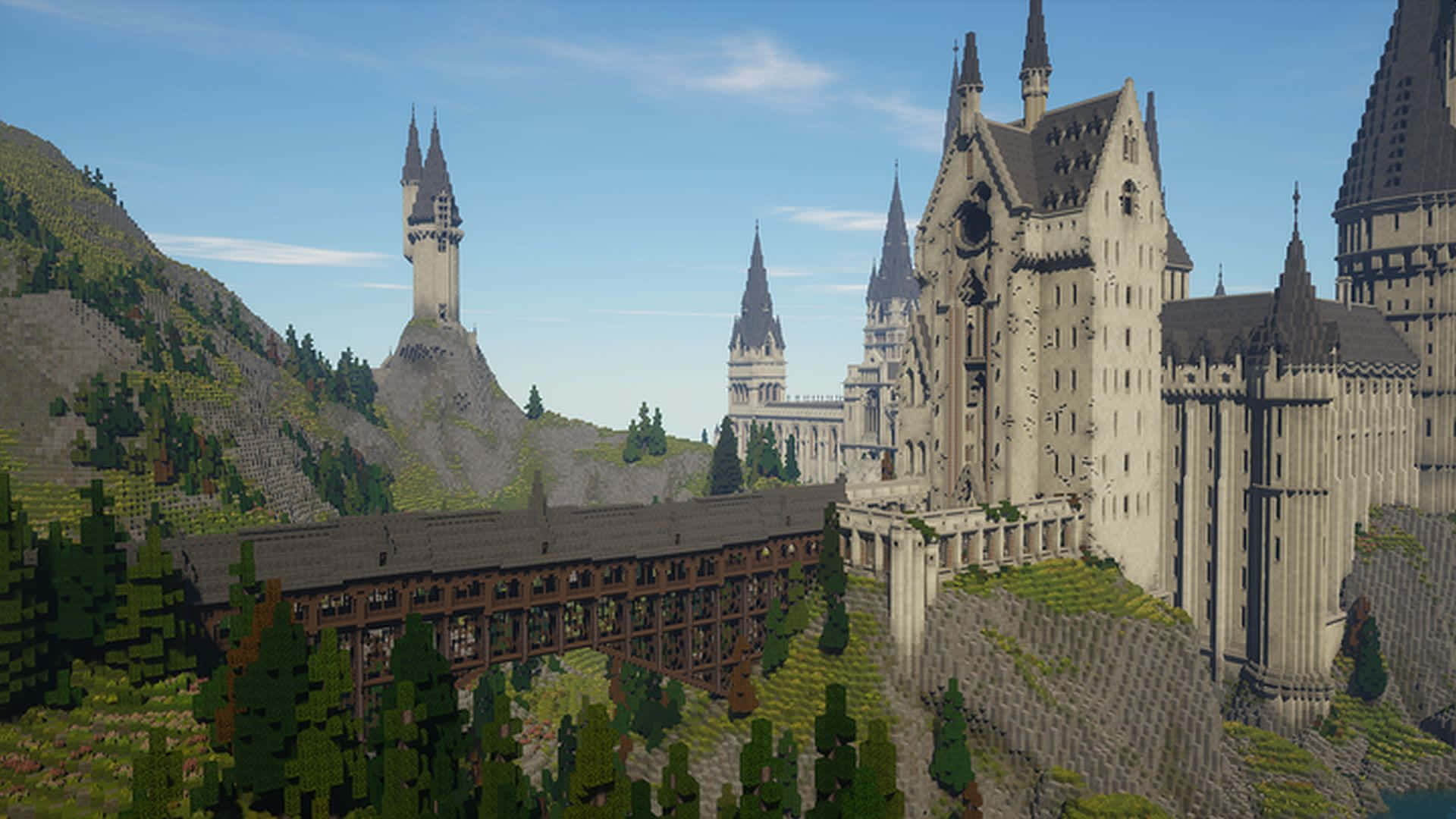 Minecraft Map 桌布 壁紙 — 一座宏偉的城堡，擁有尖塔和橋樑，坐落在山頂上，周圍是像素化的樹木，天空清澈湛藍。