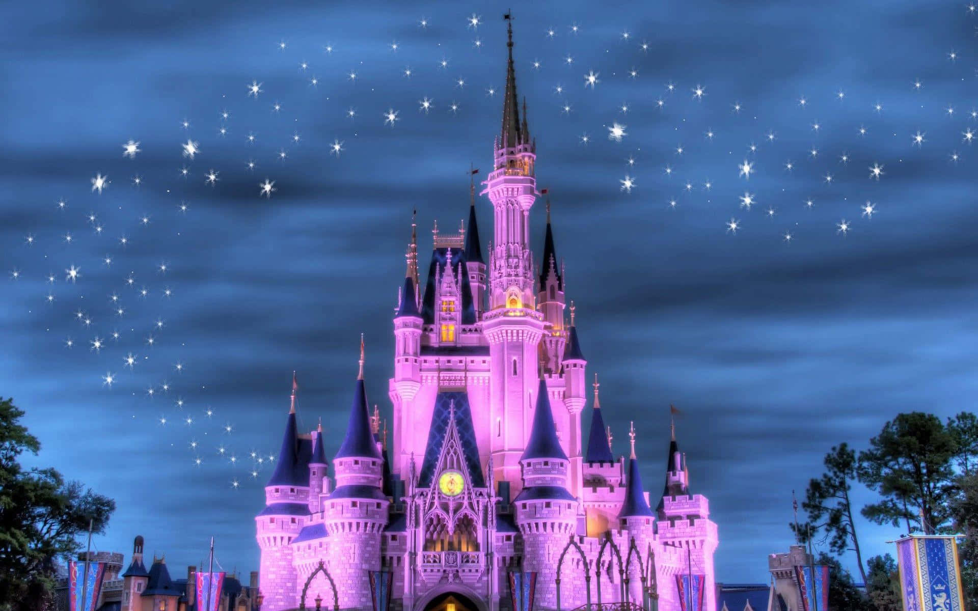 Disneyland 桌布 壁紙 — 一座宏偉的迪士尼城堡沐浴在粉紅燈光下，背景是繁星點點的暮色天空，閃耀的塔樓和節日旗幟。