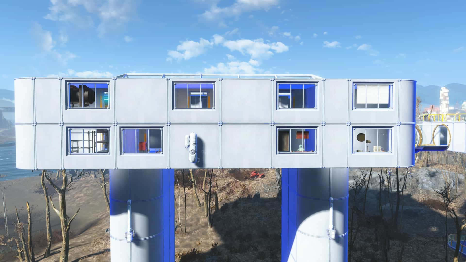 Fallout 4 Institute 桌布 壁紙 — 一座帶有藍色支撐的未來派漂浮模塊化建築在明亮的藍天下懸浮在貧瘠的景觀之上。