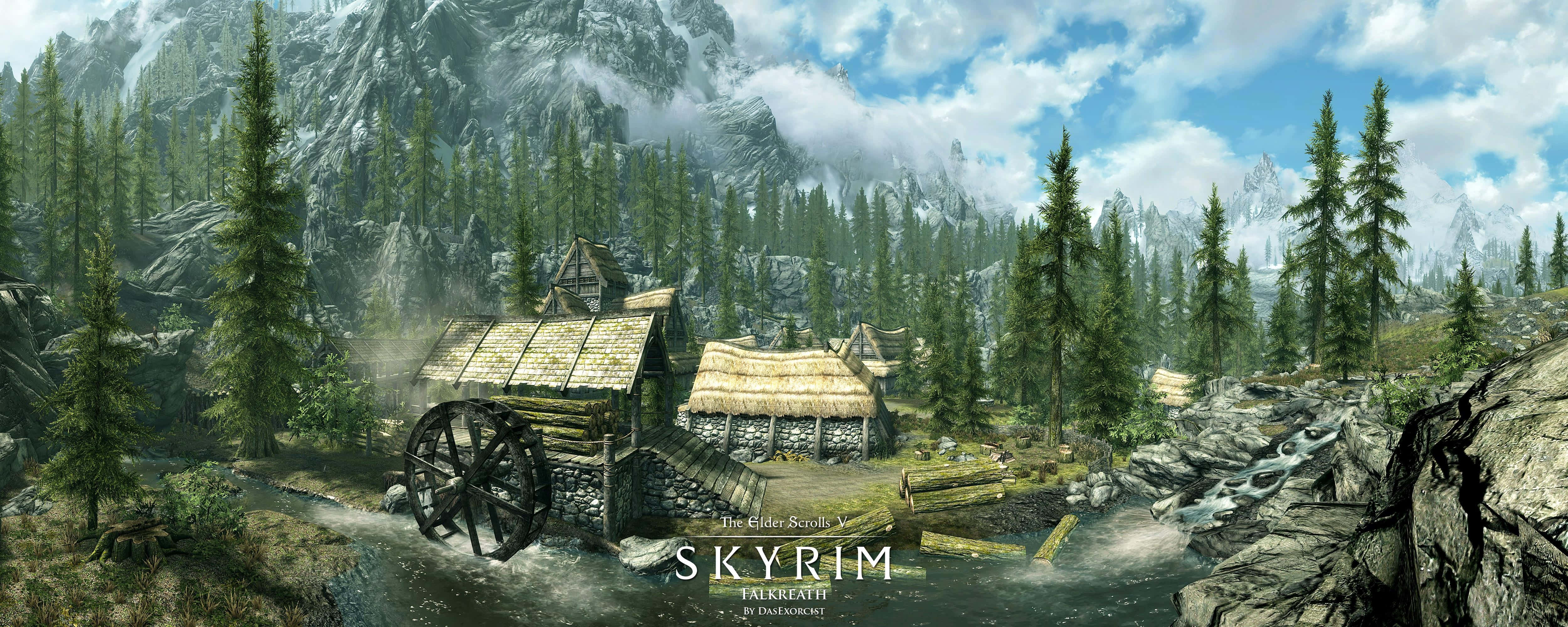 Skyrim Falkreath 桌布 壁紙 — 一座質樸的木製水車磨坊坐落在森林覆蓋的山谷中，背景有積雪覆蓋的山脈和流動的小溪，天空部分多雲。