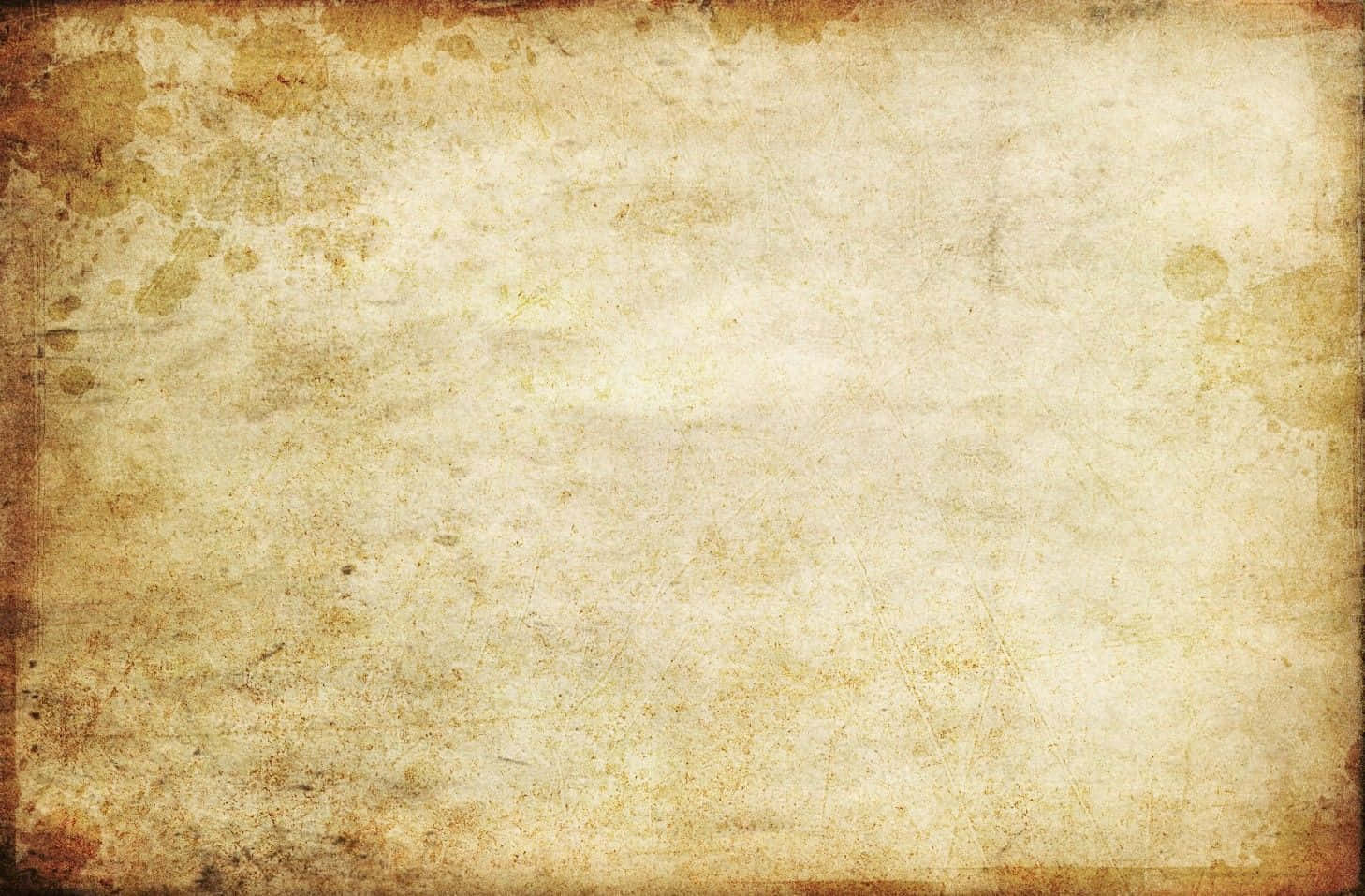 Old Paper Texture 桌布 壁紙 — 一張風化的復古羊皮紙，帶有棕色污漬和摺痕，喚起古老的歷史和懷舊感。