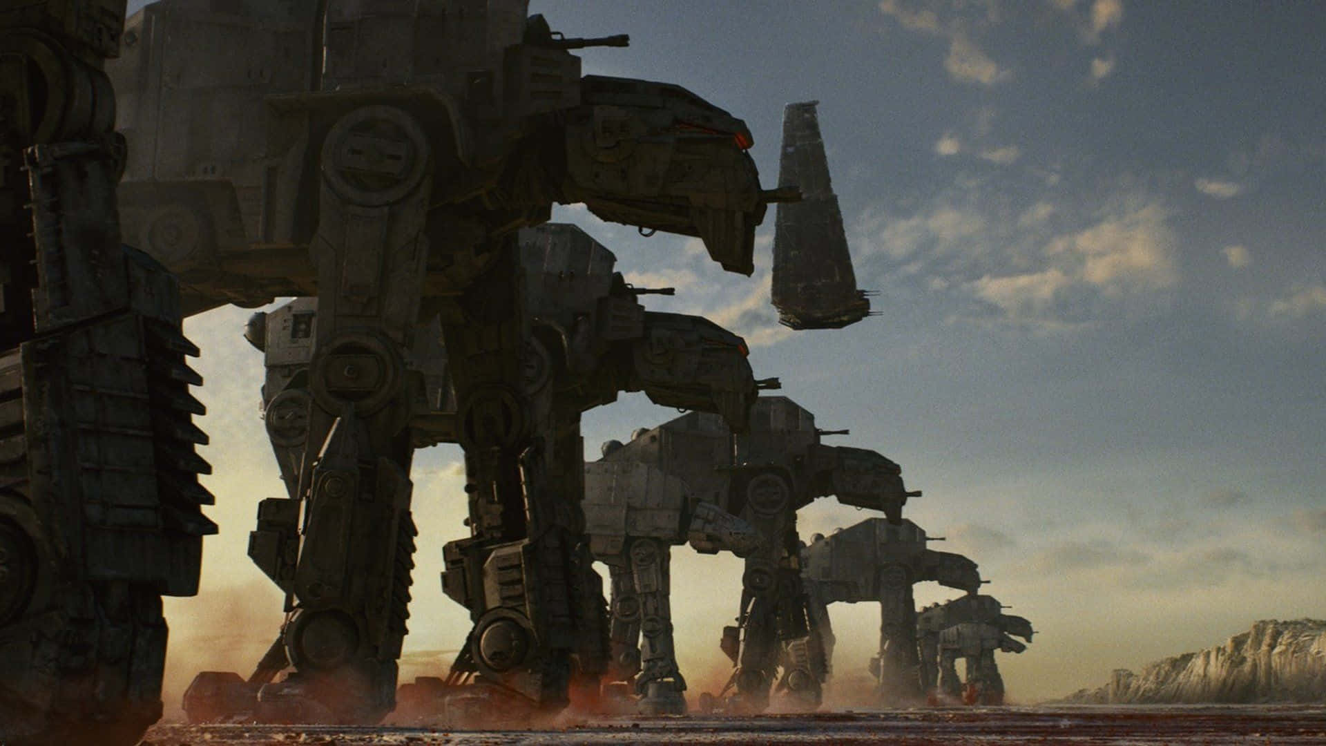 At-at 桌布 壁紙 — 一排巨大的AT-AT步行機在陰天之下，穿越塵土飛揚的沙漠戰場。