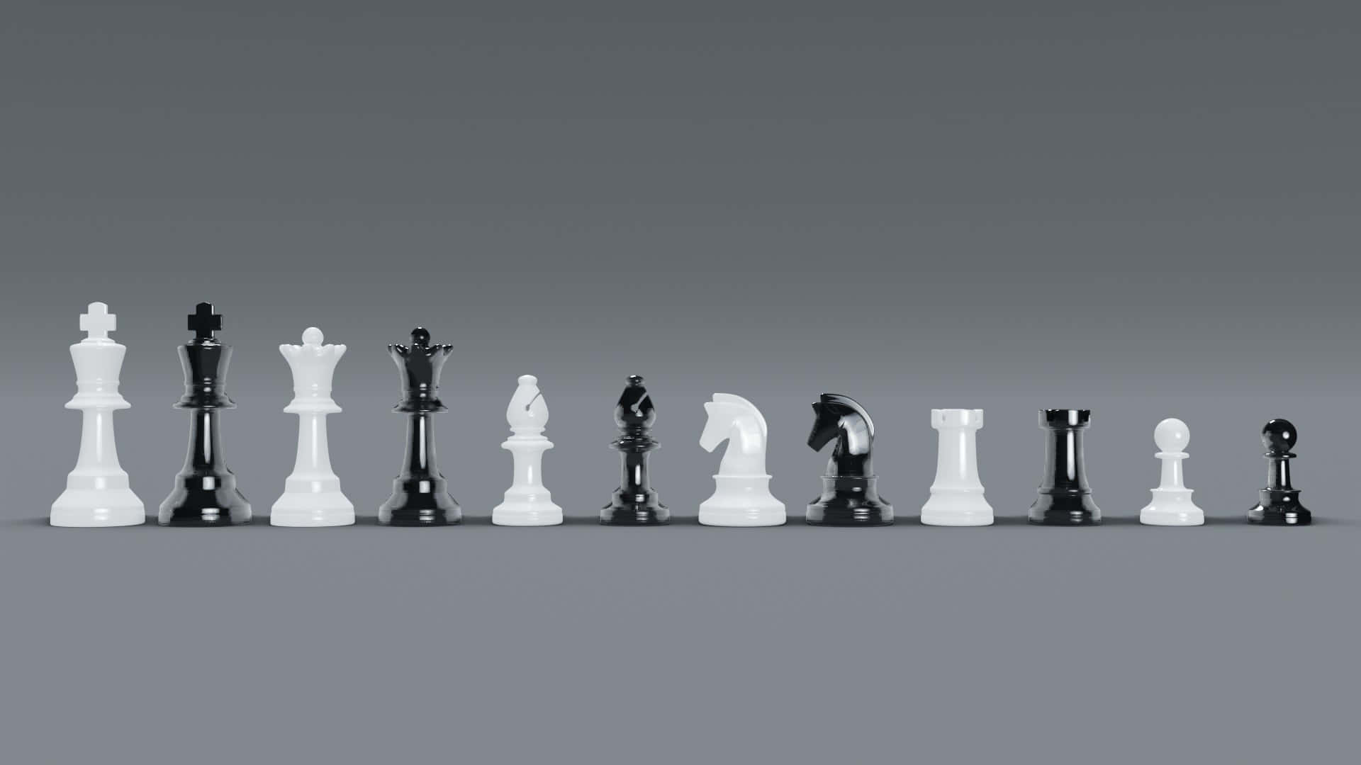 Black And White Chess 桌布 壁紙 — 一整套黑白棋子在單行中排列，背景為中性灰色漸變。