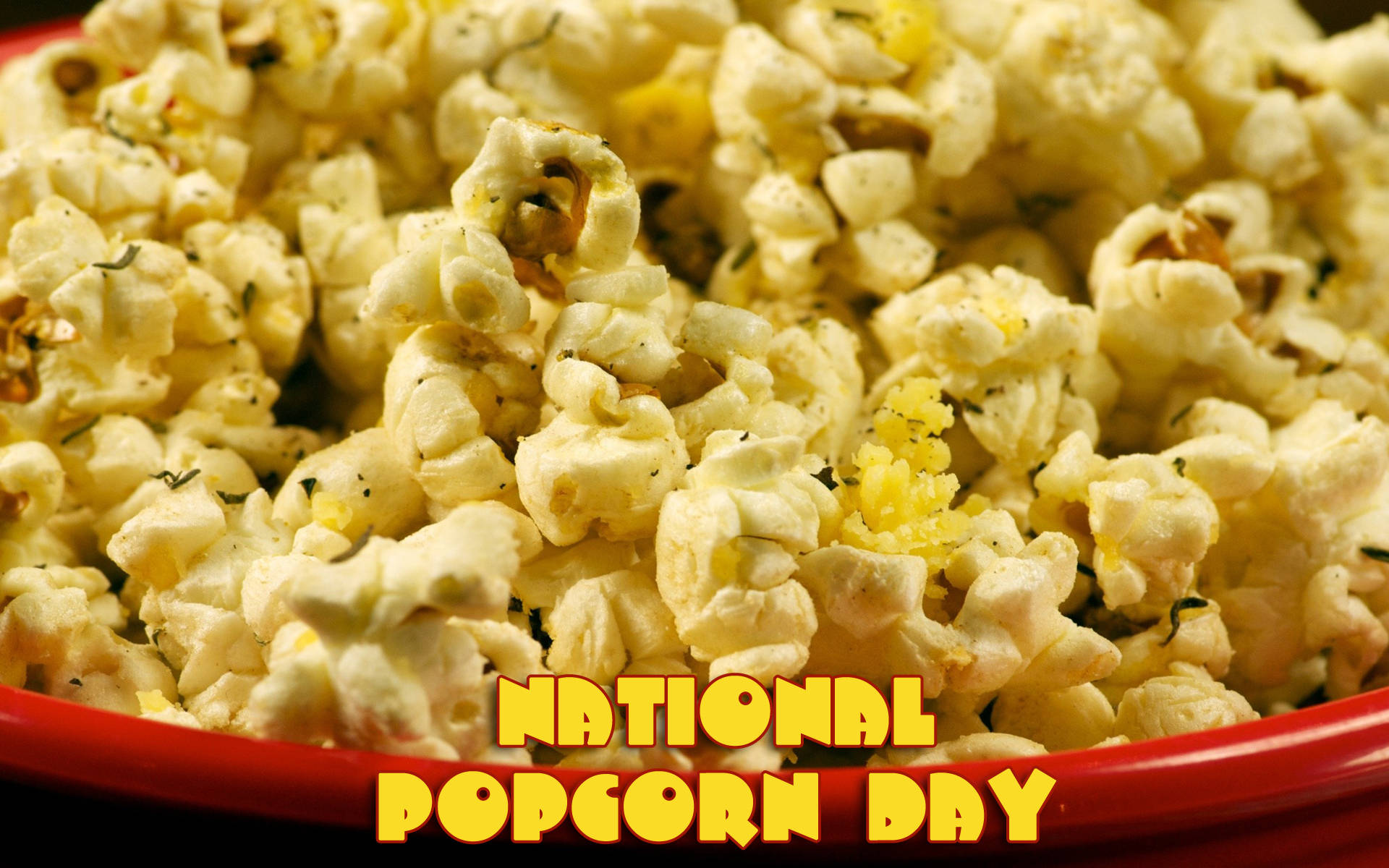 紅色碗中的鬆軟調味爆谷，帶有 National Popcorn Day 文字。 — 一月 壁紙