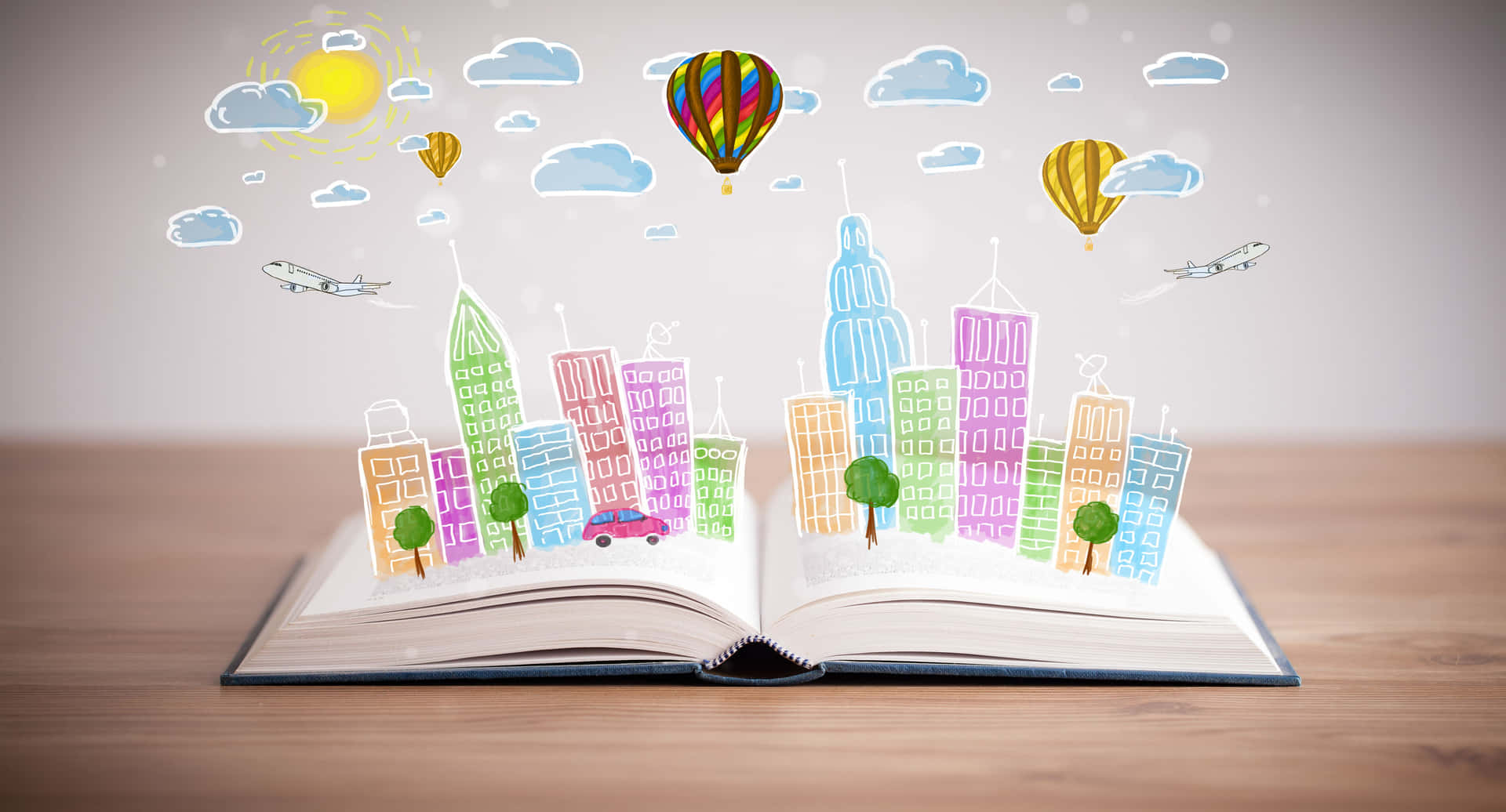 打開的書，卡通城市從書頁中浮現，天空中有熱氣球。