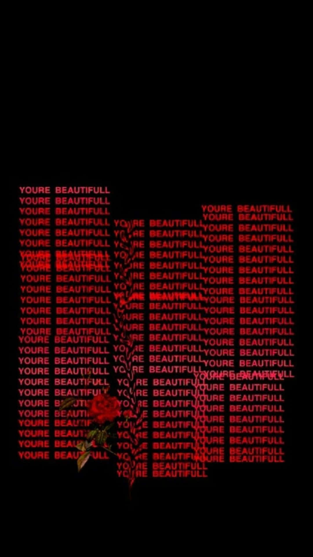 Pastel Red Aesthetic 桌布 壁紙 — 一朵帶刺的紅玫瑰從一片重複拼寫 'YOU'RE BEAUTIFULL' 的紅色文字海洋中浮現，背景為黑色。