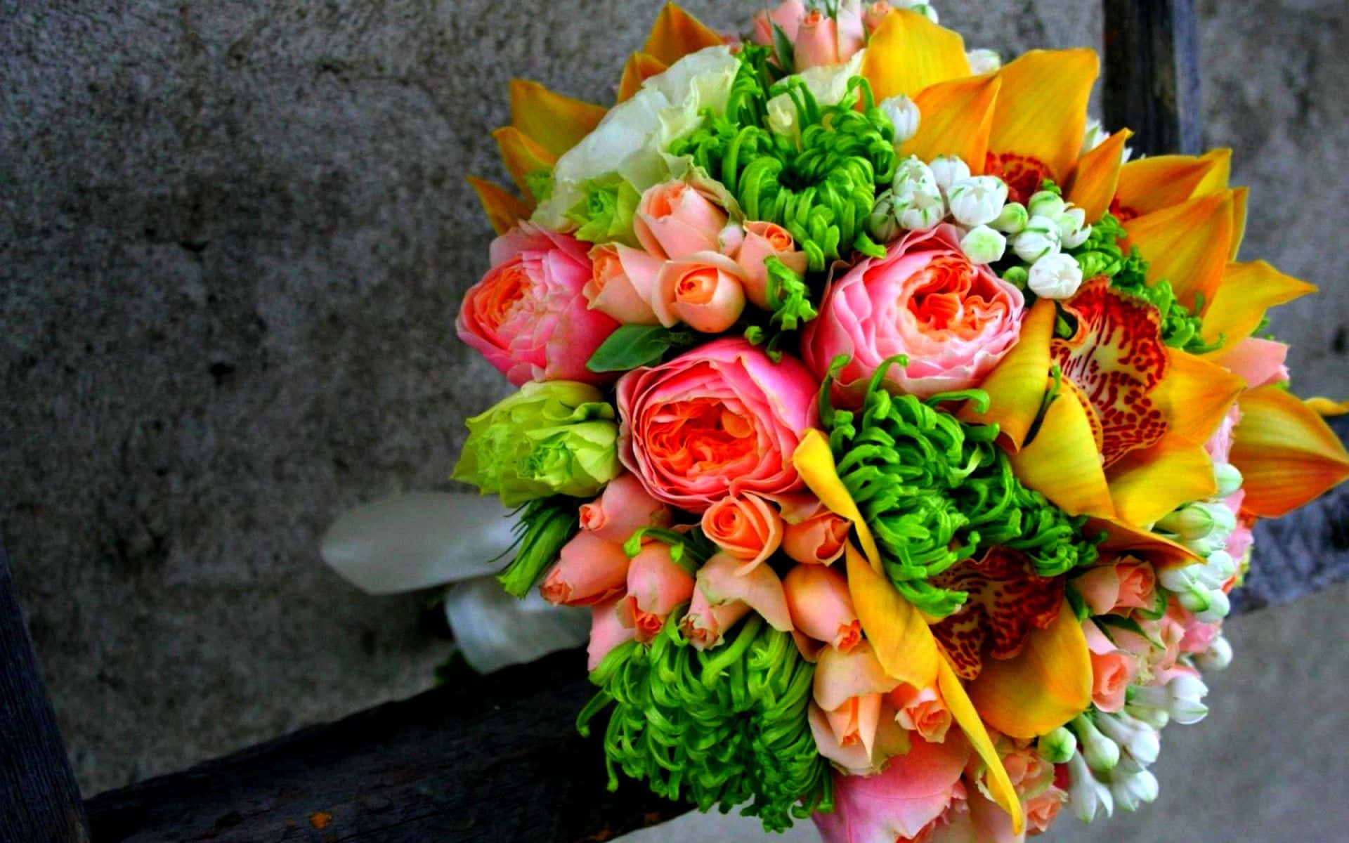 Flower Arrangement 桌布 壁紙 — 一束鮮豔的粉紅玫瑰、橙色百合和綠色葉子，倚在風化的石牆上。